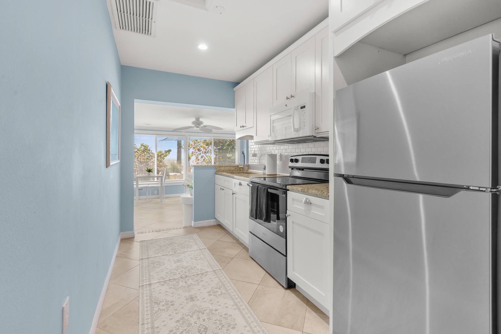 You'll love cooking in this bright, fully-equipped kitchen with stainless steel appliances and coastal blue walls.