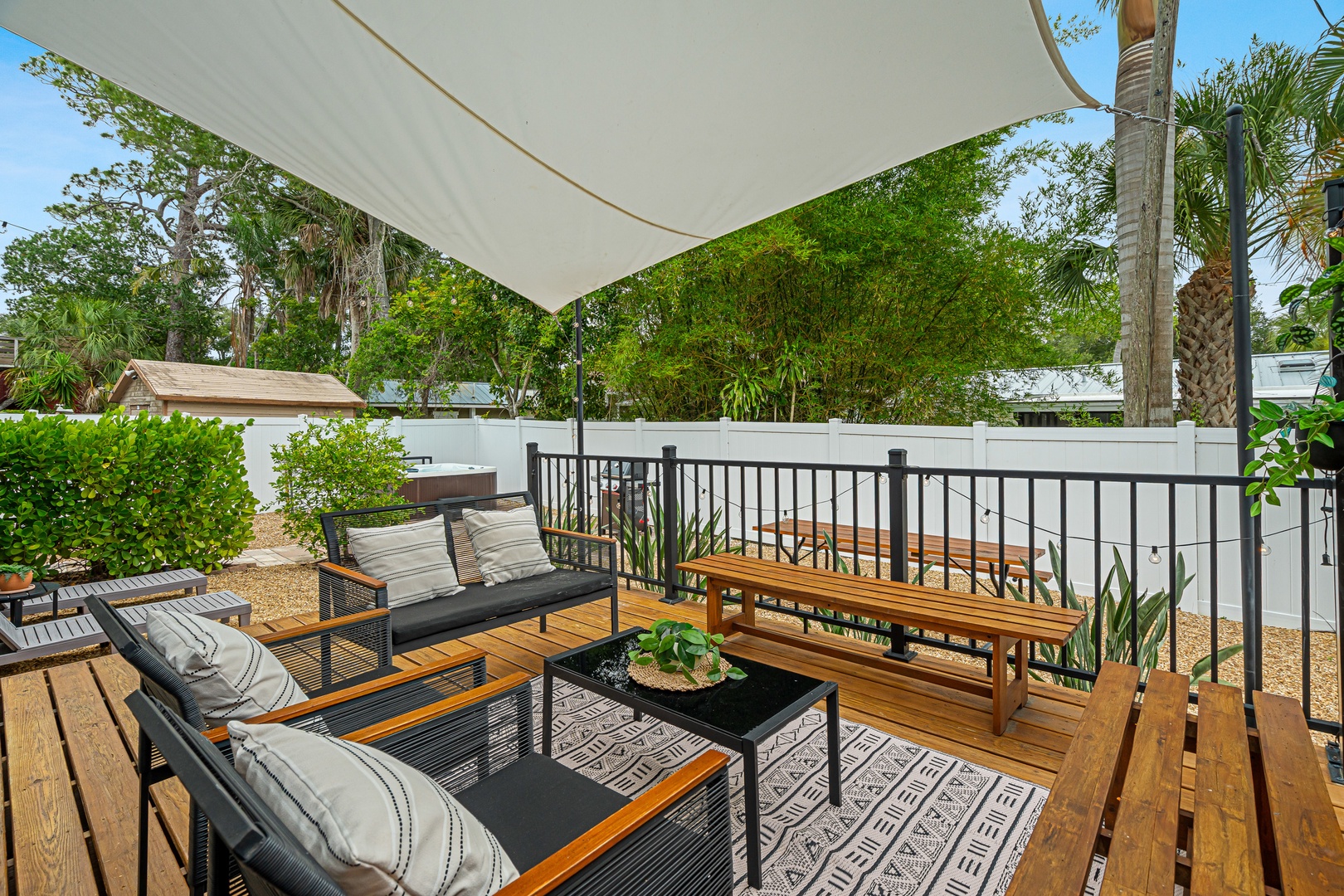 Relax on your private deck, shaded by a sail canopy and surrounded by tropical greenery. This inviting outdoor space offers comfortable seating for morning coffee or evening conversation.