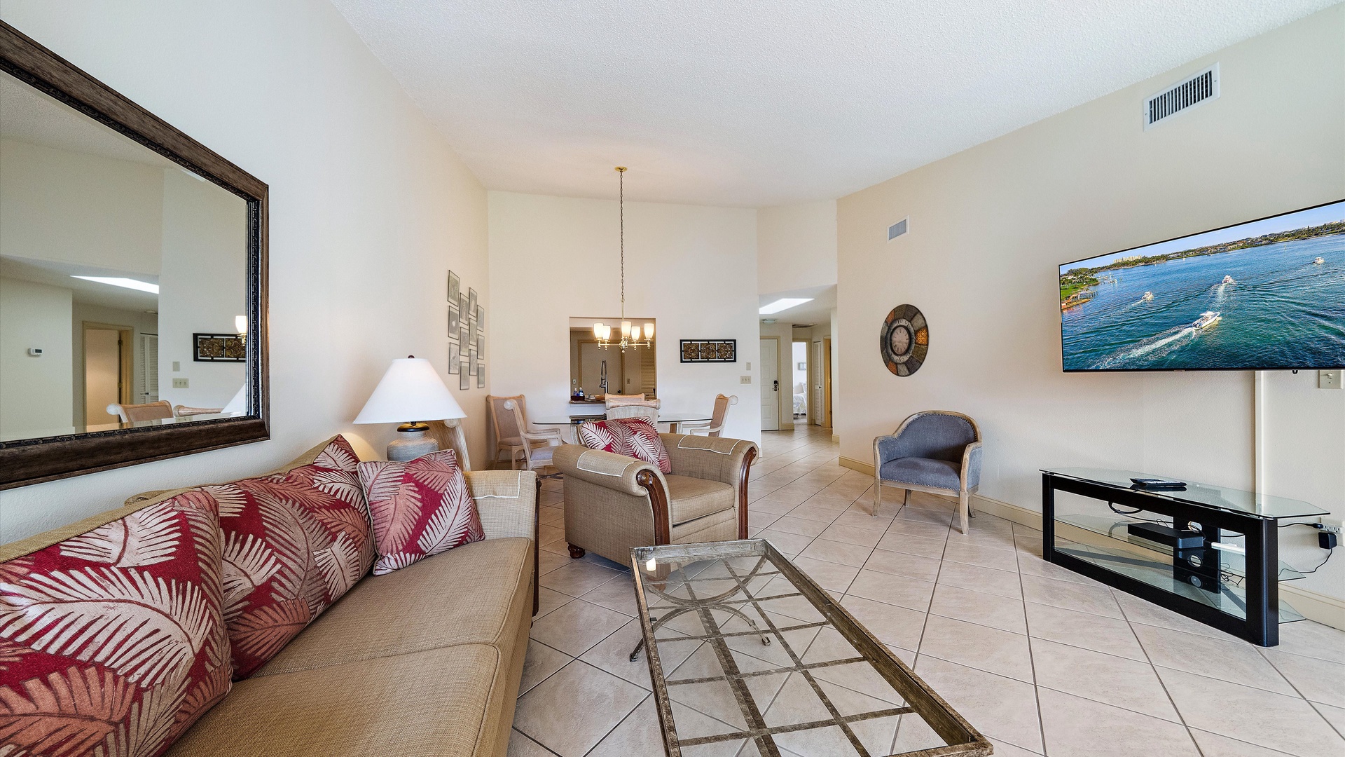 Relax in your spacious living area with comfortable seating, coastal décor, and a large TV—perfect for unwinding after a day of adventure.