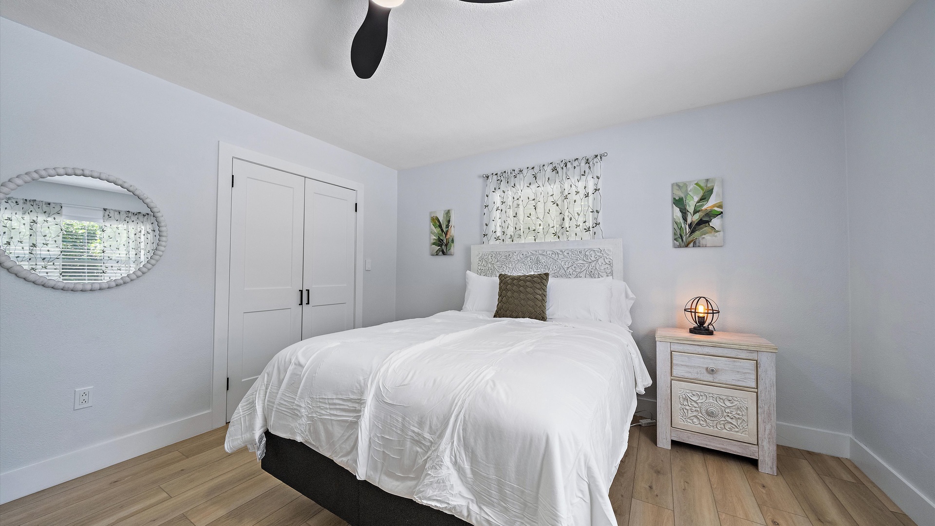 Slip into soft white linens and let natural light wake you gently in this peaceful bedroom. The subtle botanical touches and warm wood floors create a calm, restorative retreat.