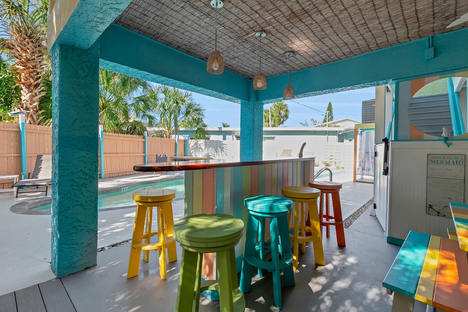 Sip your morning coffee at this cheerful poolside bar, where colorful stools and tropical vibes set the tone for your perfect vacation day.