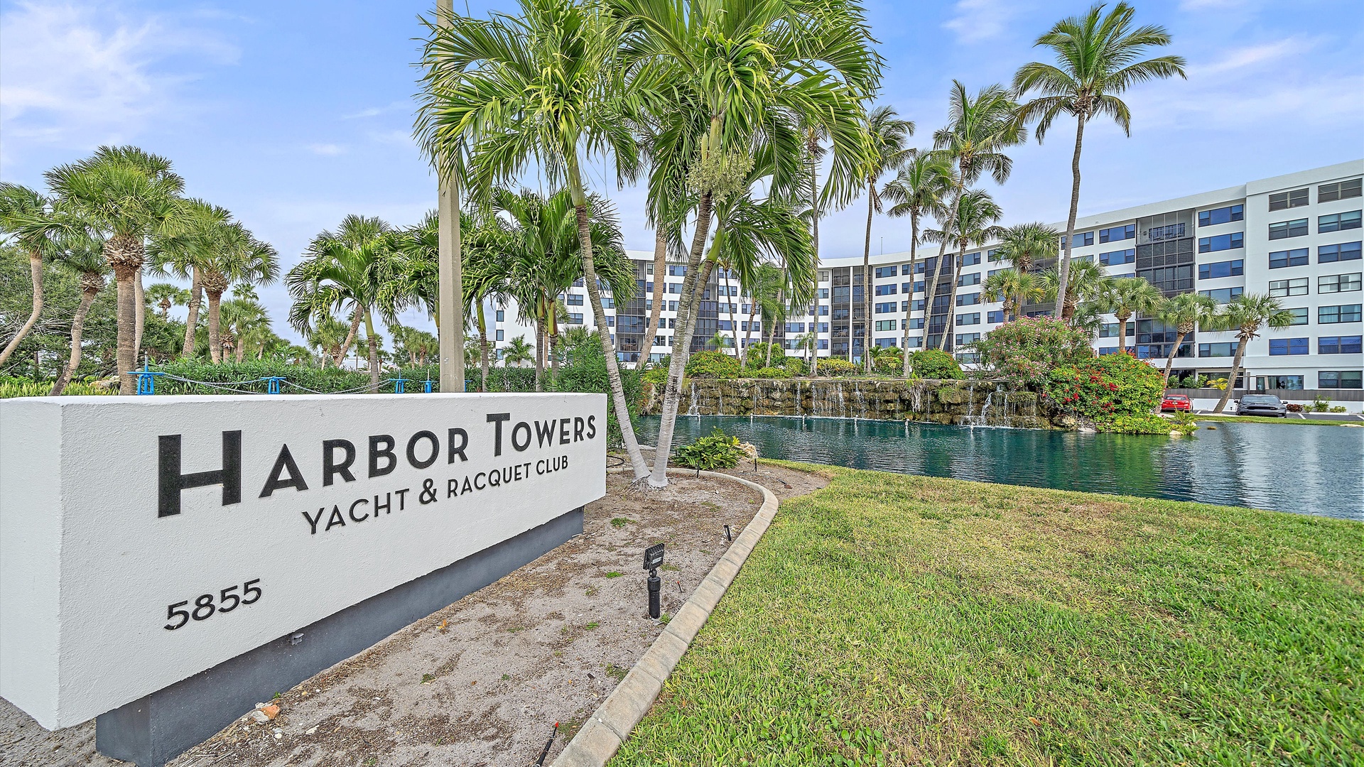 Harbor Towers Yacht & Racquet Club entrance sign at 5855, marking the gateway to this waterfront resort community.