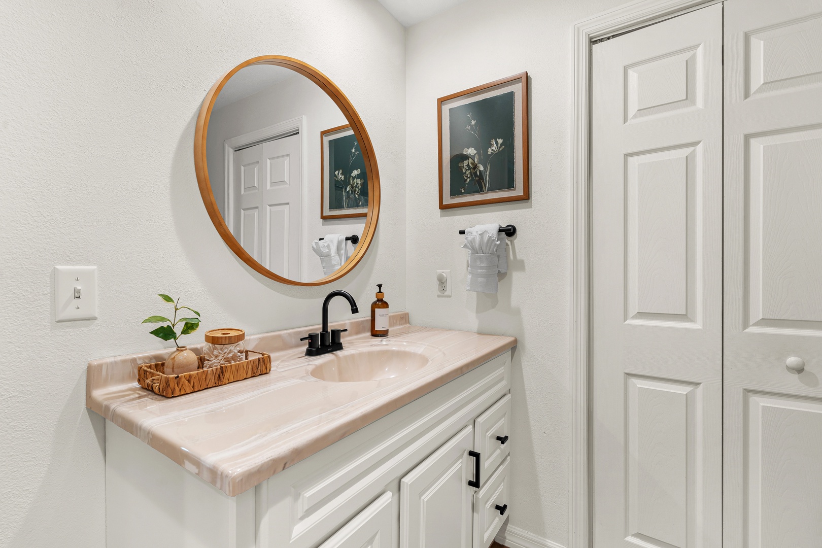Step into your stylish bathroom, where warm wood tones and thoughtful touches create a serene start to your day. Fresh towels and luxe finishes await.