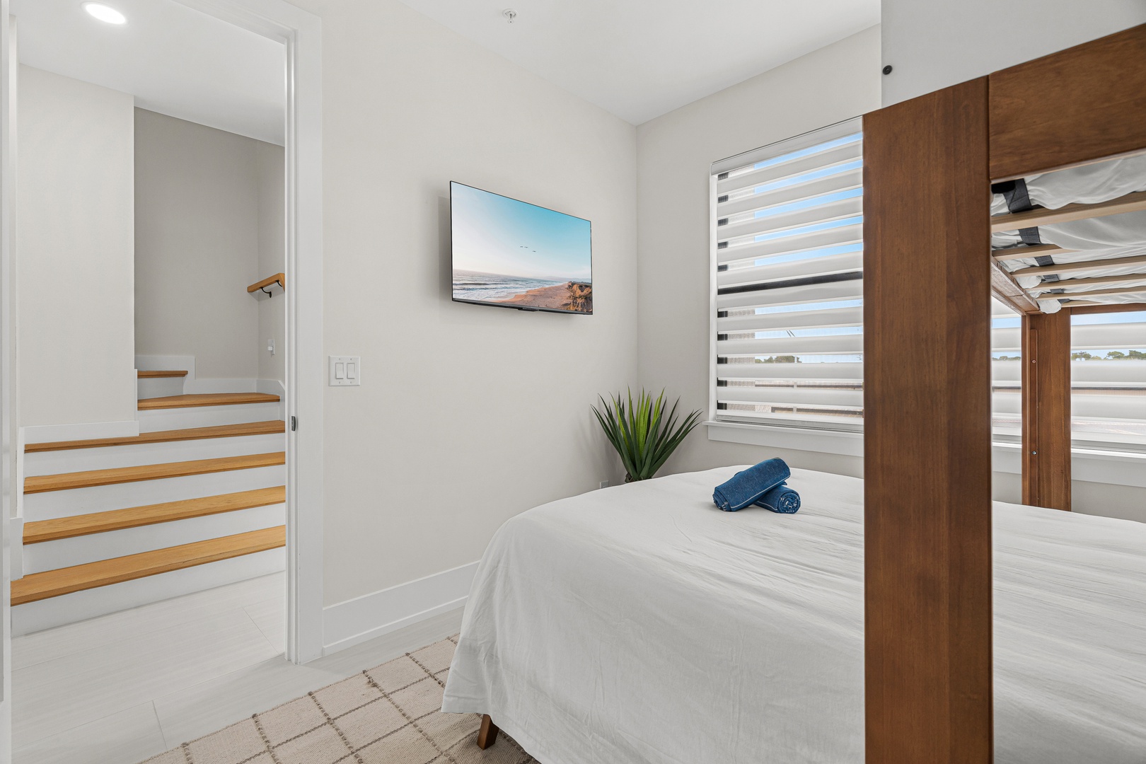 Unwind in your peaceful bedroom with crisp linens, natural light, and modern touches that create a serene retreat after a day of adventure.