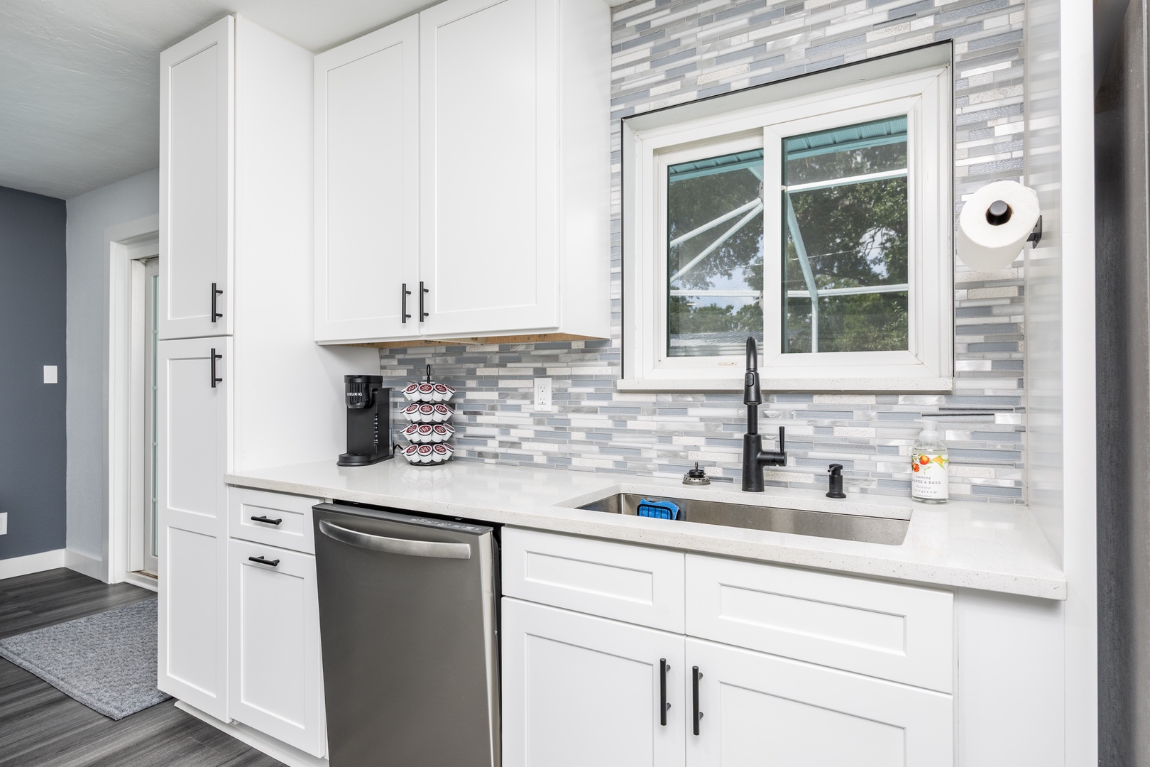 Your fully equipped modern kitchen features sleek white cabinets, quartz countertops, and everything you need to create memorable meals during your stay.