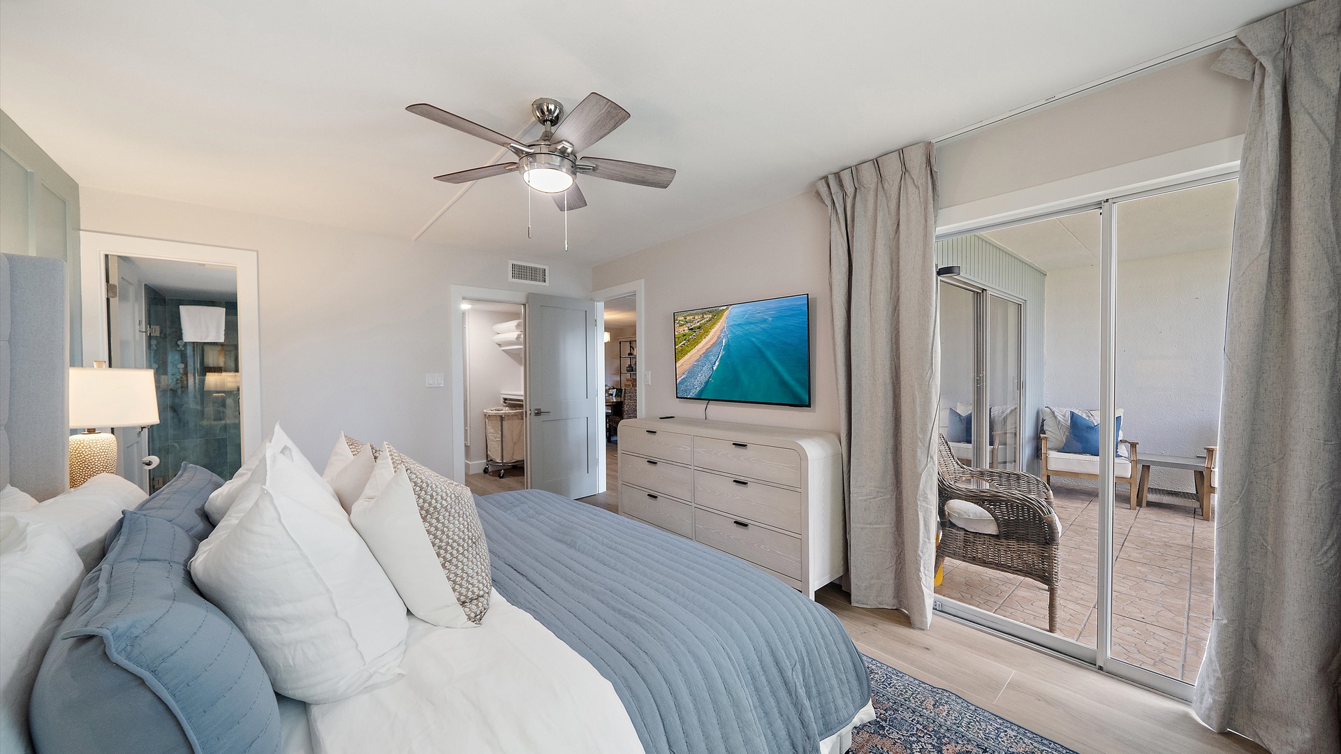 Relax in your coastal-inspired bedroom with plush bedding, ceiling fan comfort, and private balcony access for morning coffee moments.