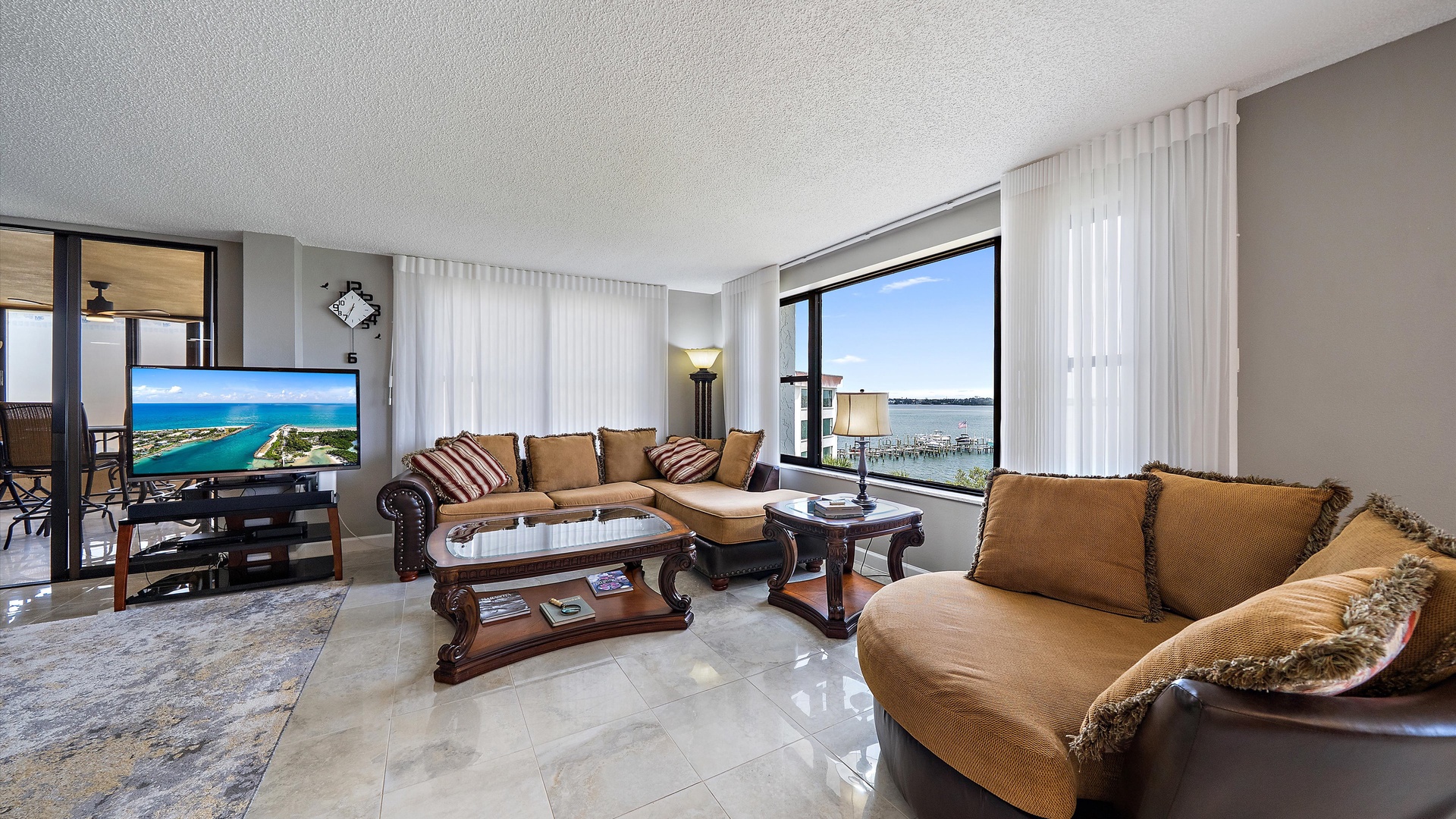 Relax in your spacious living room with stunning water views through floor-to-ceiling windows and comfortable seating for memorable evenings.