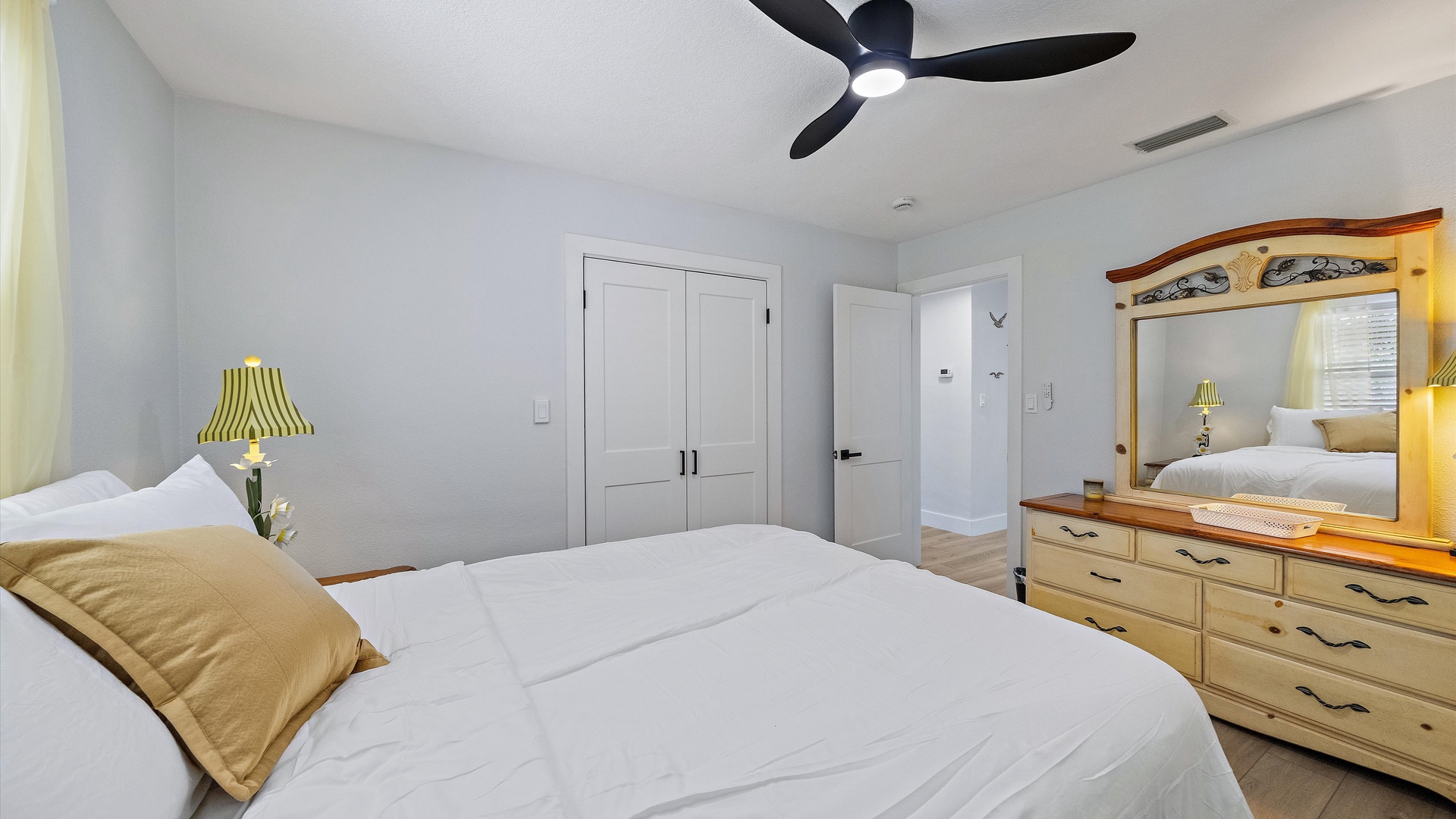 Unwind in your serene bedroom with soft linens, thoughtful decor, and a ceiling fan to keep you comfortable year-round.