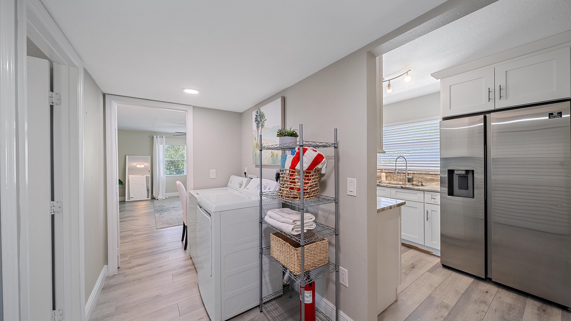 Step into your bright, open living space where modern convenience meets beachy charm. This fully equipped kitchen leads seamlessly into airy rooms designed for your ultimate coastal getaway.