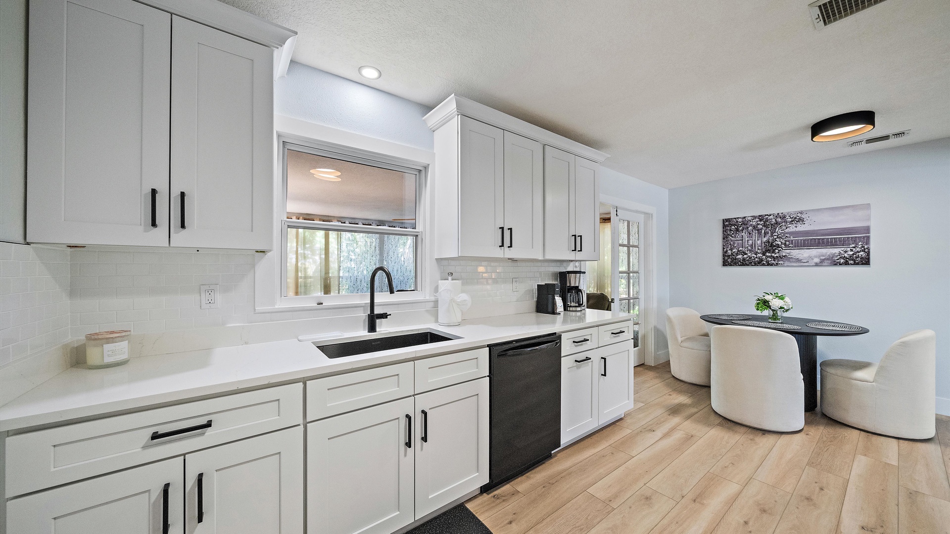 Step into your bright, modern kitchen where everything you need is at your fingertips. Sleek countertops and ample cabinet space make meal prep a breeze, while the adjoining dining nook invites you to savor morning coffee or gather with friends.