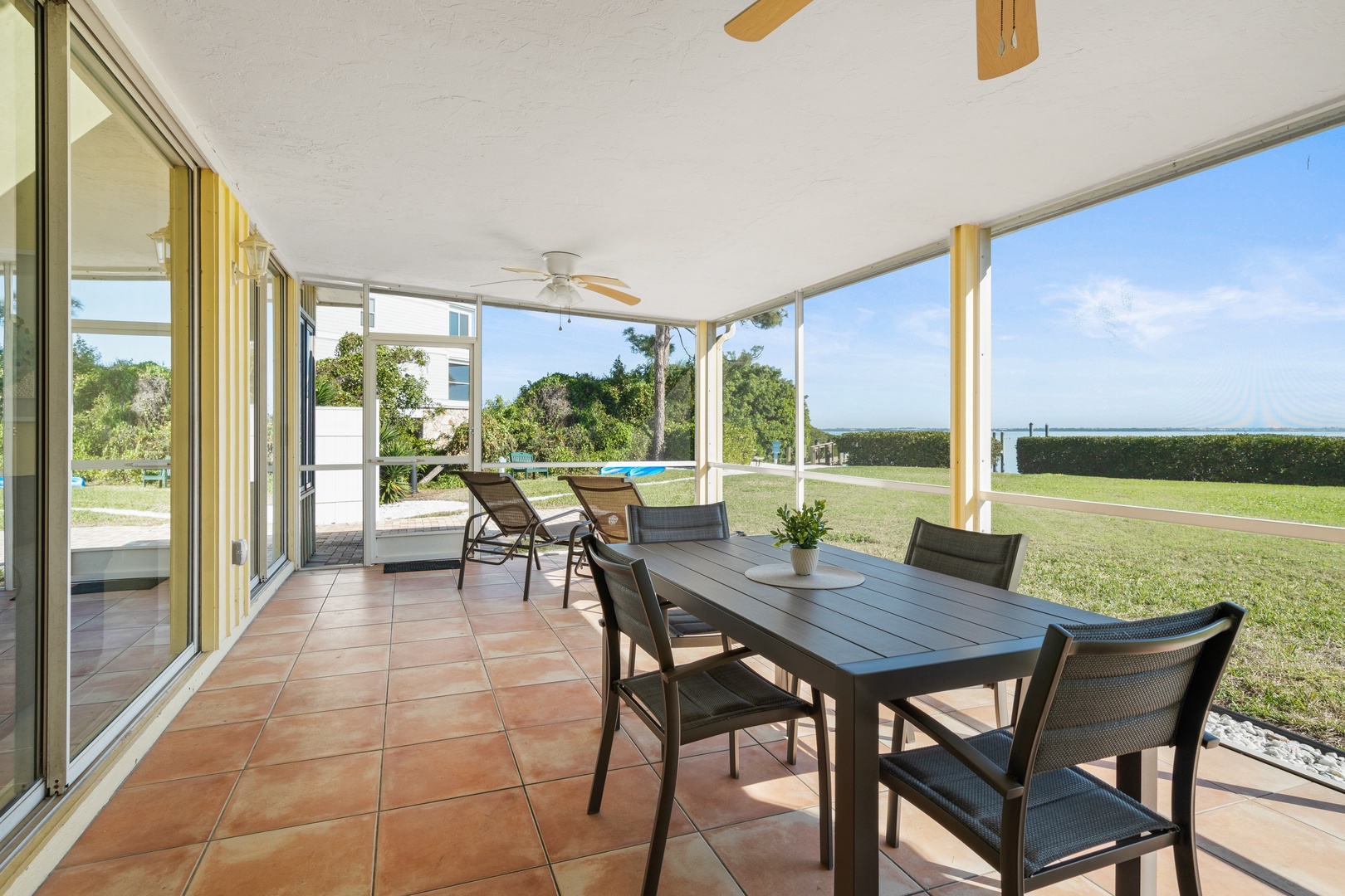 Enjoy your morning coffee at this spacious covered terrace with panoramic views and comfortable outdoor dining.