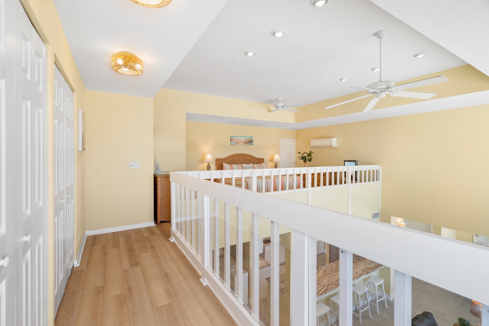 Upstairs landing with warm yellow walls and ceiling fan creates a welcoming space between your bedrooms.