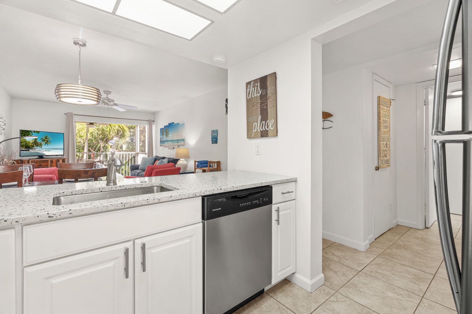 The spacious kitchen overlooks the open living area with private patio.