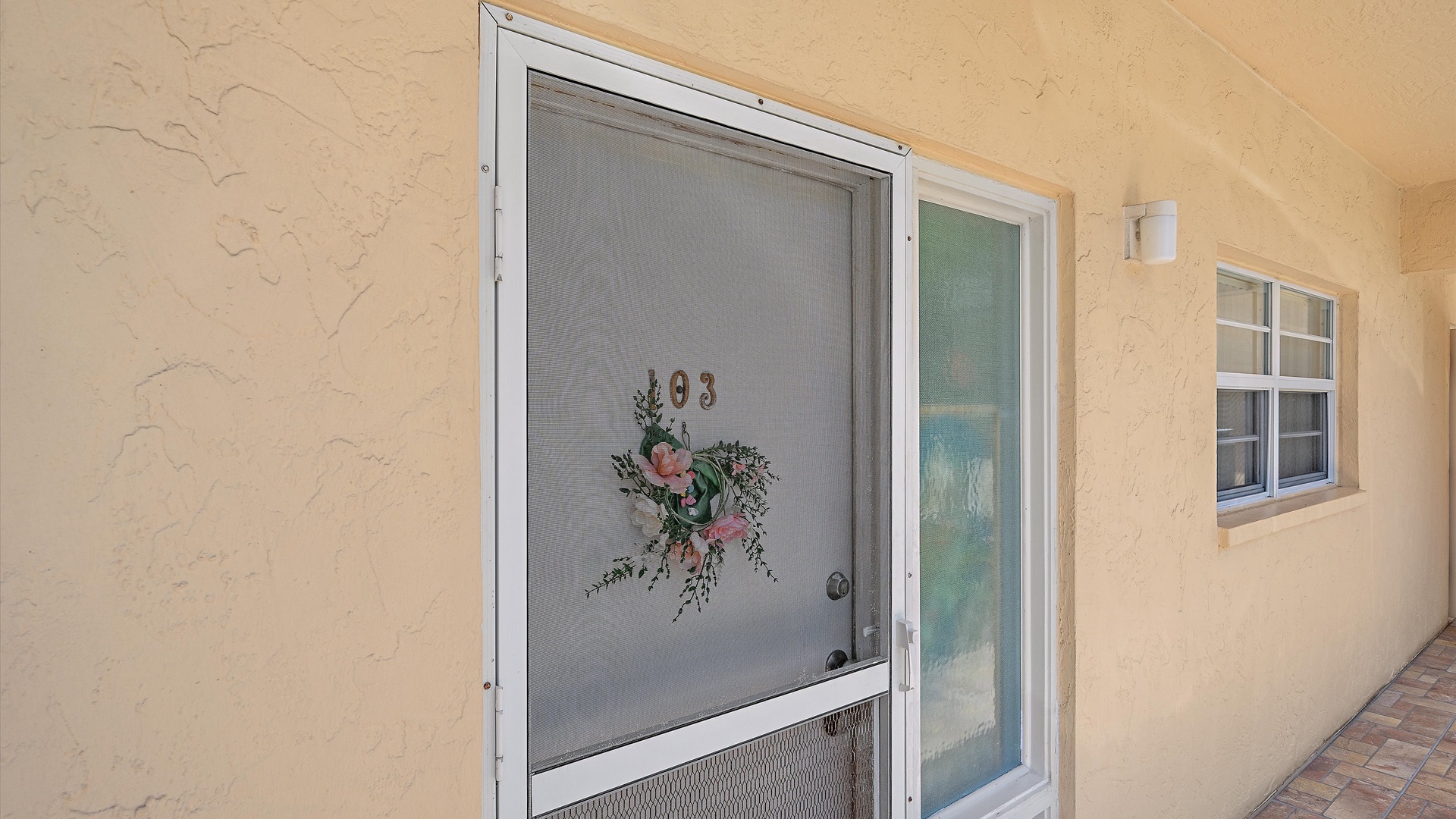 Charming entrance with a welcoming floral wreath greets you at this cozy rental, setting the tone for your relaxing getaway in a peaceful setting.