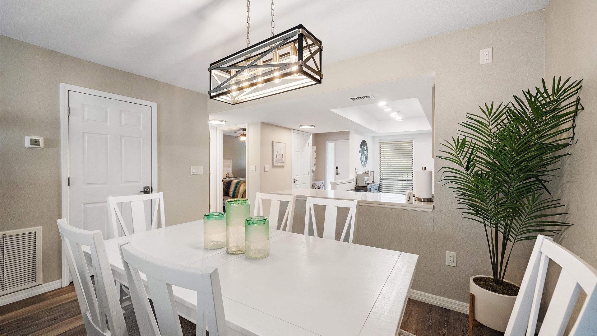 Gather around your spacious dining table under a striking modern chandelier. The open layout flows seamlessly into the living area, creating a bright and welcoming space for shared meals and laughter.