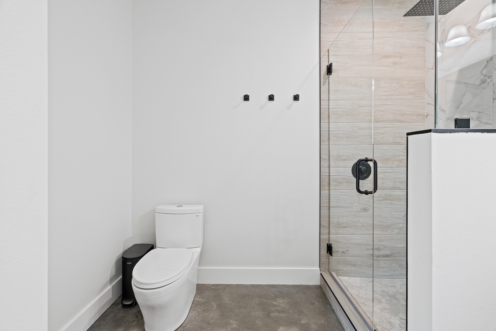 Crisp, modern bathroom with sleek glass shower and luxurious tile—your private sanctuary awaits after a day of exploring.