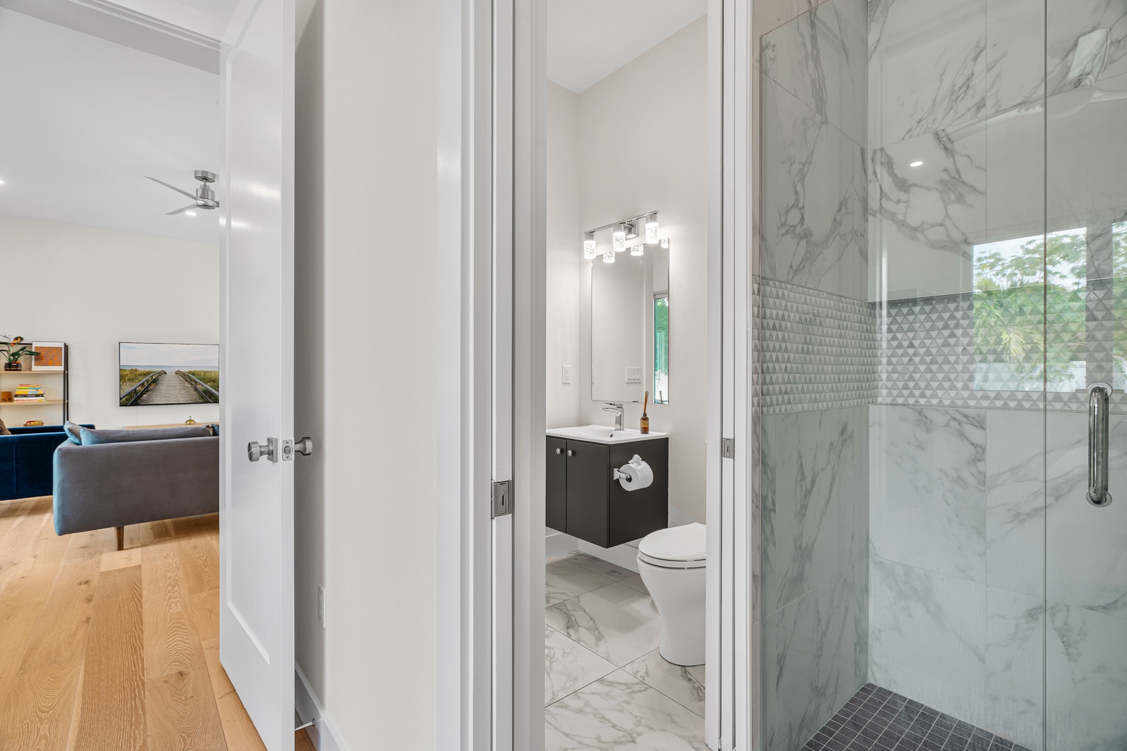 Step into your private spa-like retreat with floor-to-ceiling marble, a sleek walk-in shower, and modern fixtures that make every refresh feel luxurious.