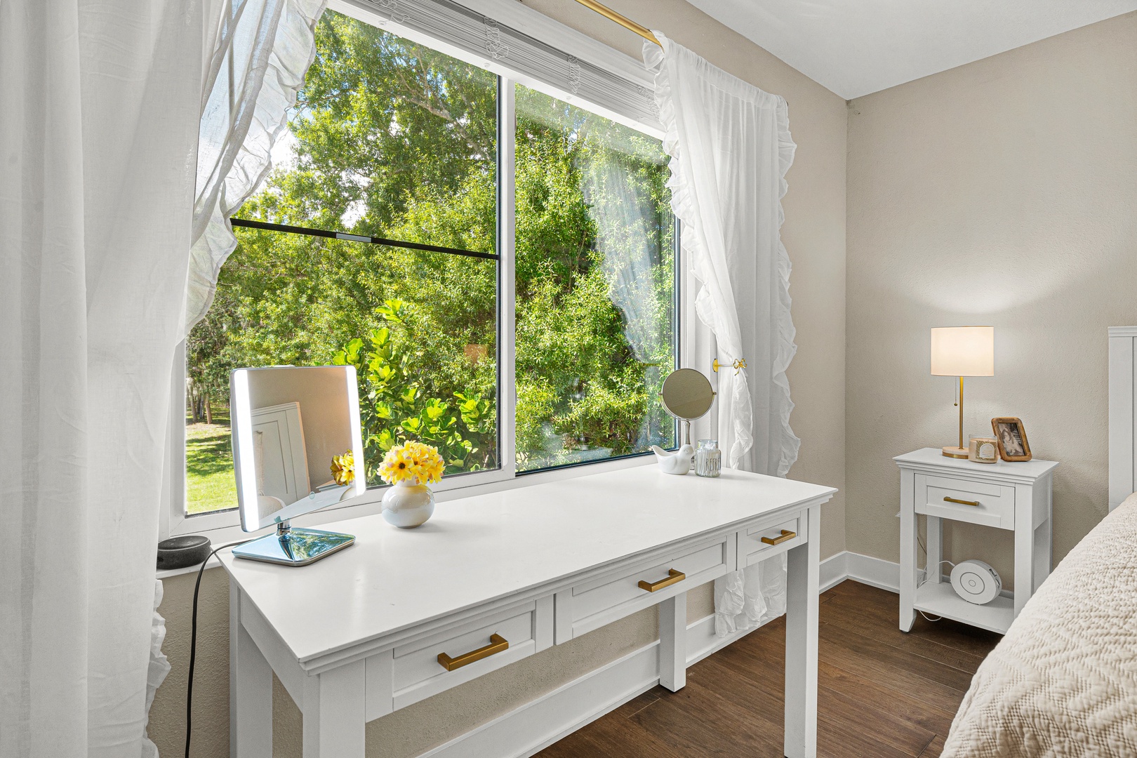 Soft morning light spills through your bedroom window, framing lush greenery and creating the perfect spot to start your day. This peaceful corner invites relaxation and reflection.