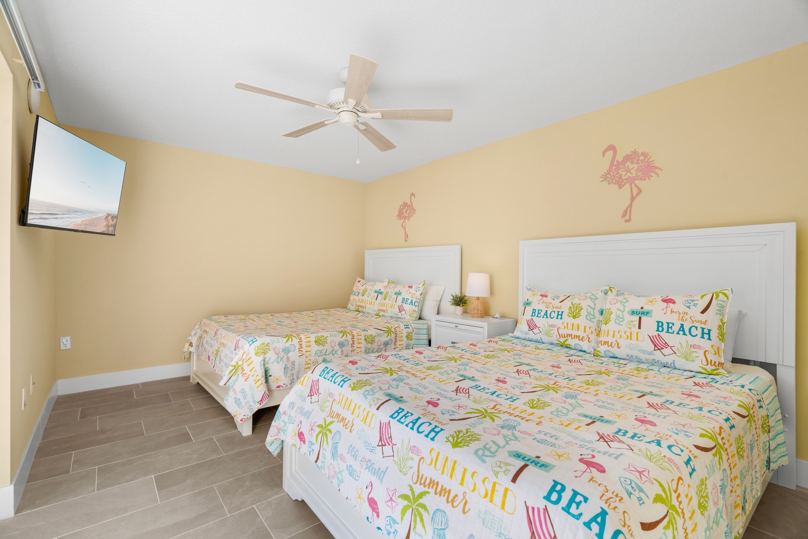 Sleep soundly in your cheerful twin bedroom with tropical-themed bedding and a ceiling fan to keep you cool.