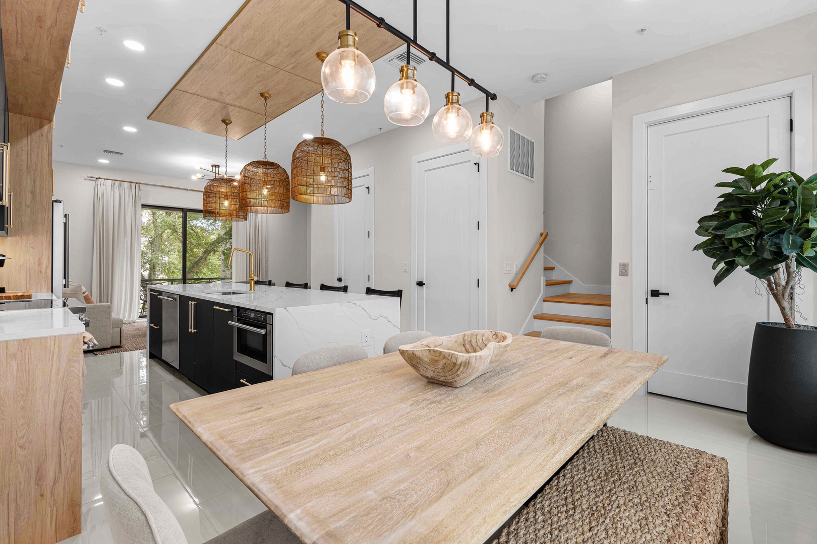 Open-concept kitchen with natural light, sleek countertops, and warm wood accents. Spacious island with ambient pendant lighting—ideal for gatherings.