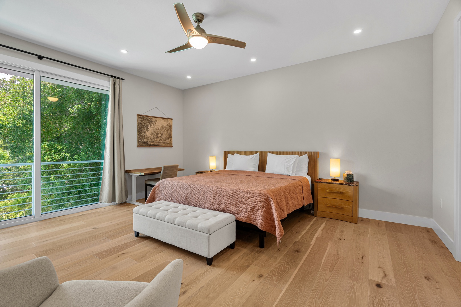Your restful bedroom offers serene garden views through floor-to-ceiling windows, inviting natural light to wake you gently each morning as you relax beneath the warm glow of bedside lamps.