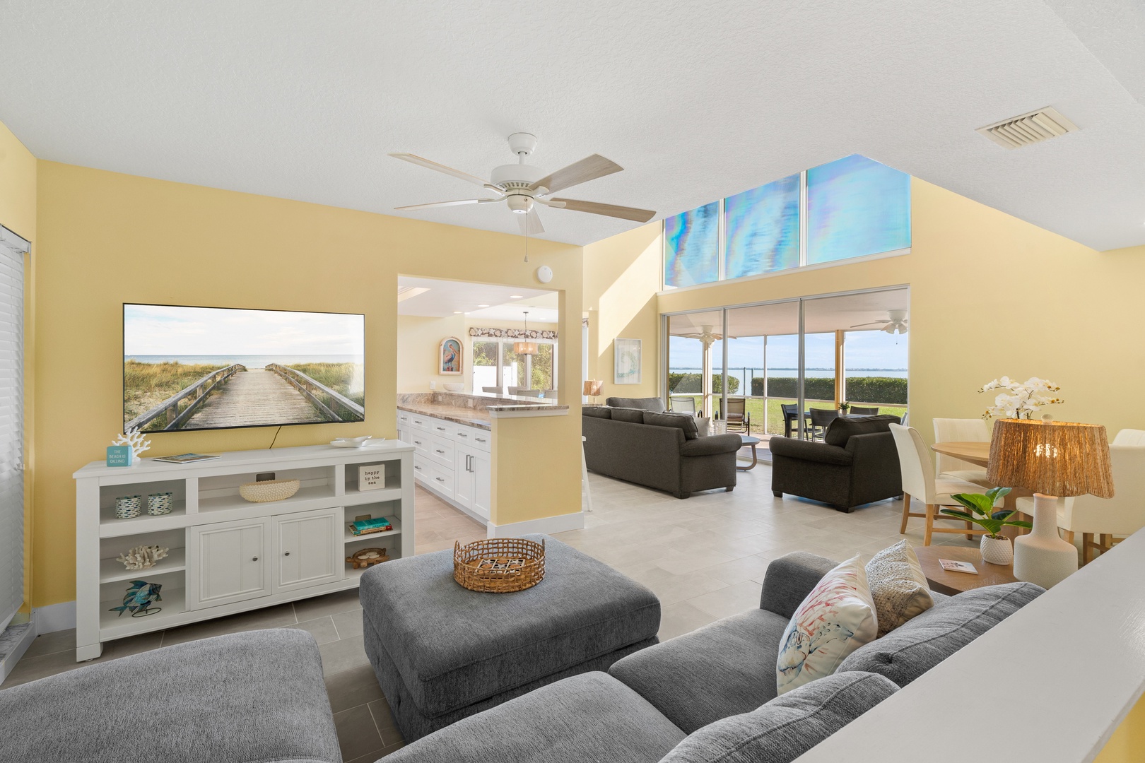 Sink into plush seating while natural light floods through soaring windows, creating your perfect retreat for relaxation and entertainment.