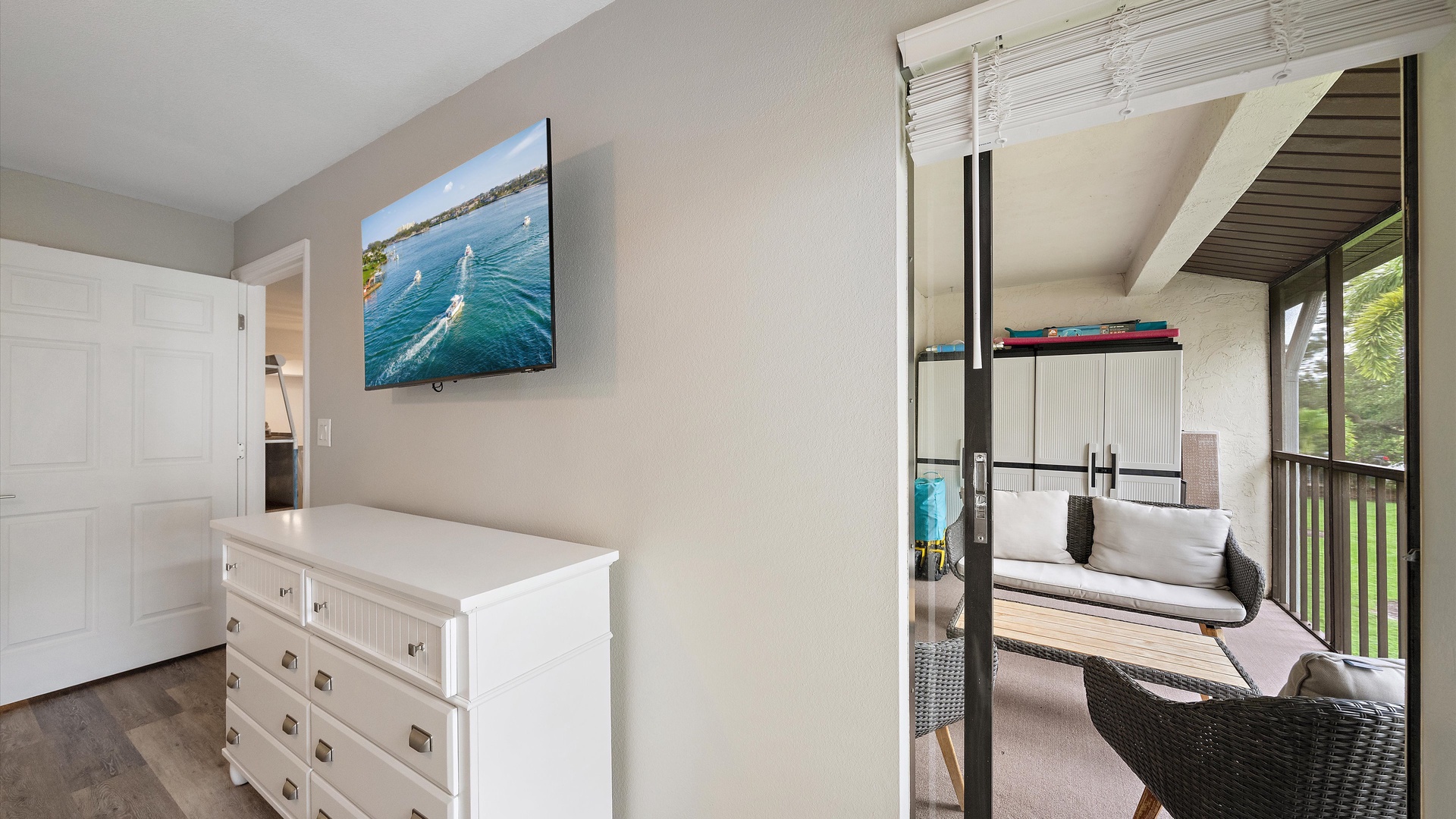 Your primary bedroom opens to a private balcony where you can unwind in wicker seating surrounded by greenery—perfect for morning coffee or evening relaxation.