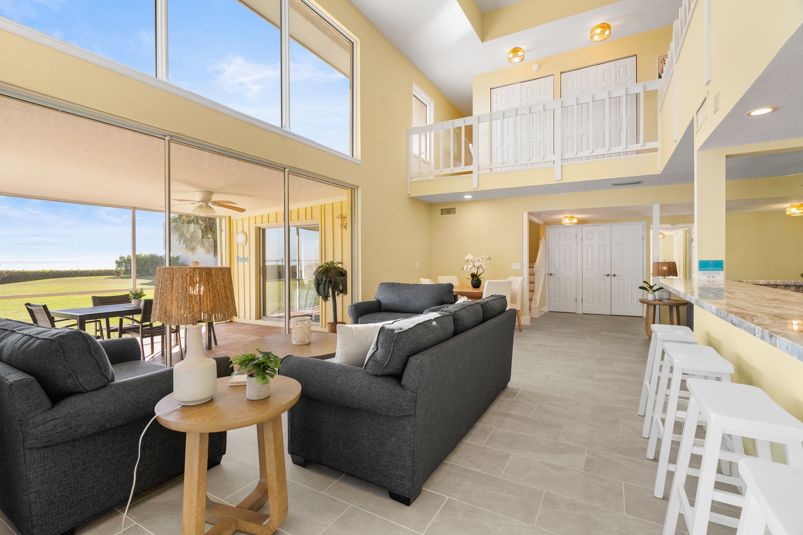 Sink into plush sofas in your bright, open living space with soaring ceilings and stunning panoramic views.