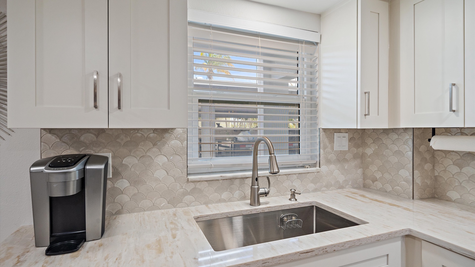 Your modern kitchen features elegant marble countertops, stylish fish-scale backsplash, and premium coffee maker for perfect mornings.