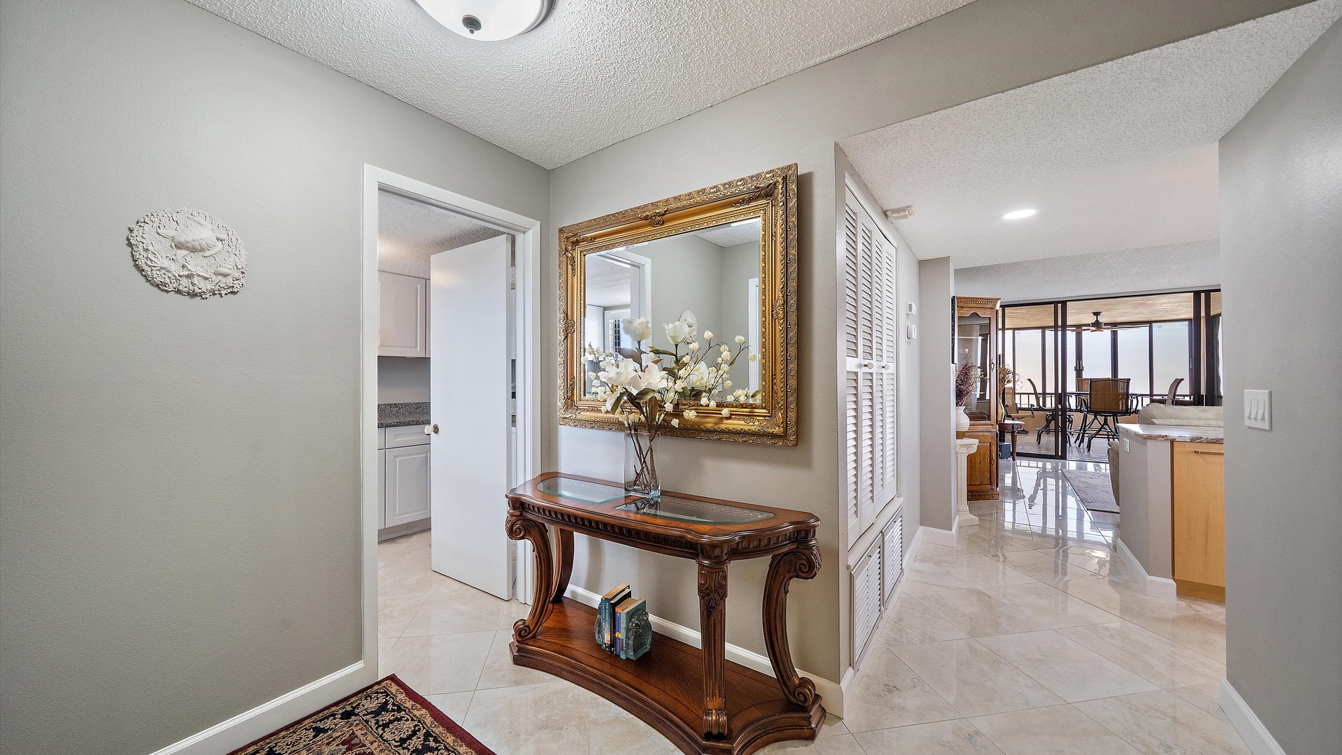 Step into your elegant foyer where warm hospitality begins, featuring gleaming marble floors and refined furnishings that welcome you home.