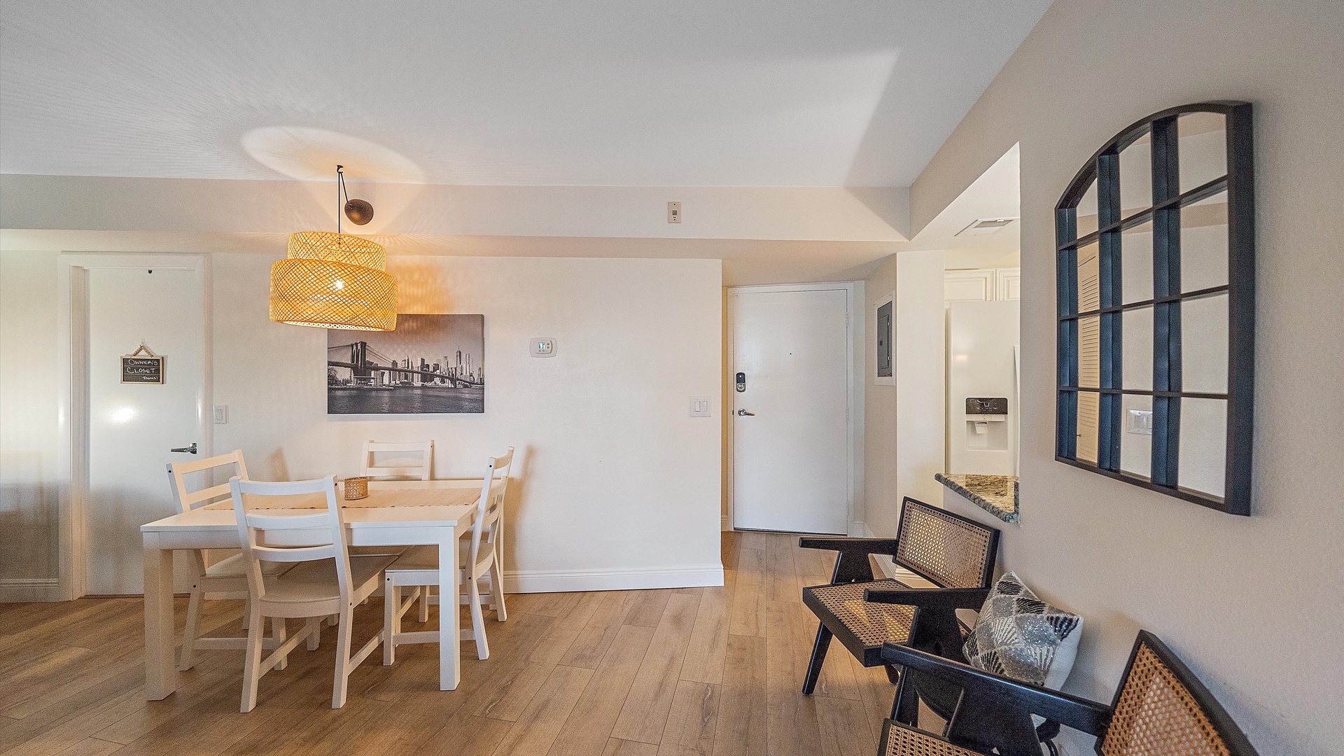 Your bright and airy dining space features a welcoming table for shared meals, complemented by stylish woven lighting and comfortable seating areas for relaxing.