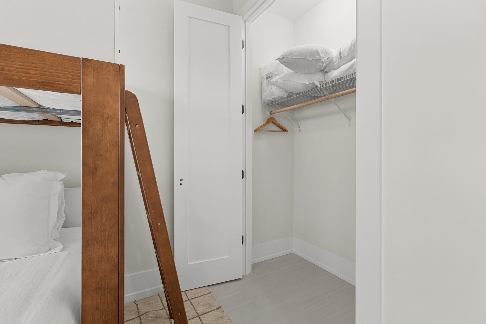 Your bedroom features a cozy bunk bed and built-in closet storage with hanging space, providing comfortable sleeping arrangements and convenient organization for your stay.