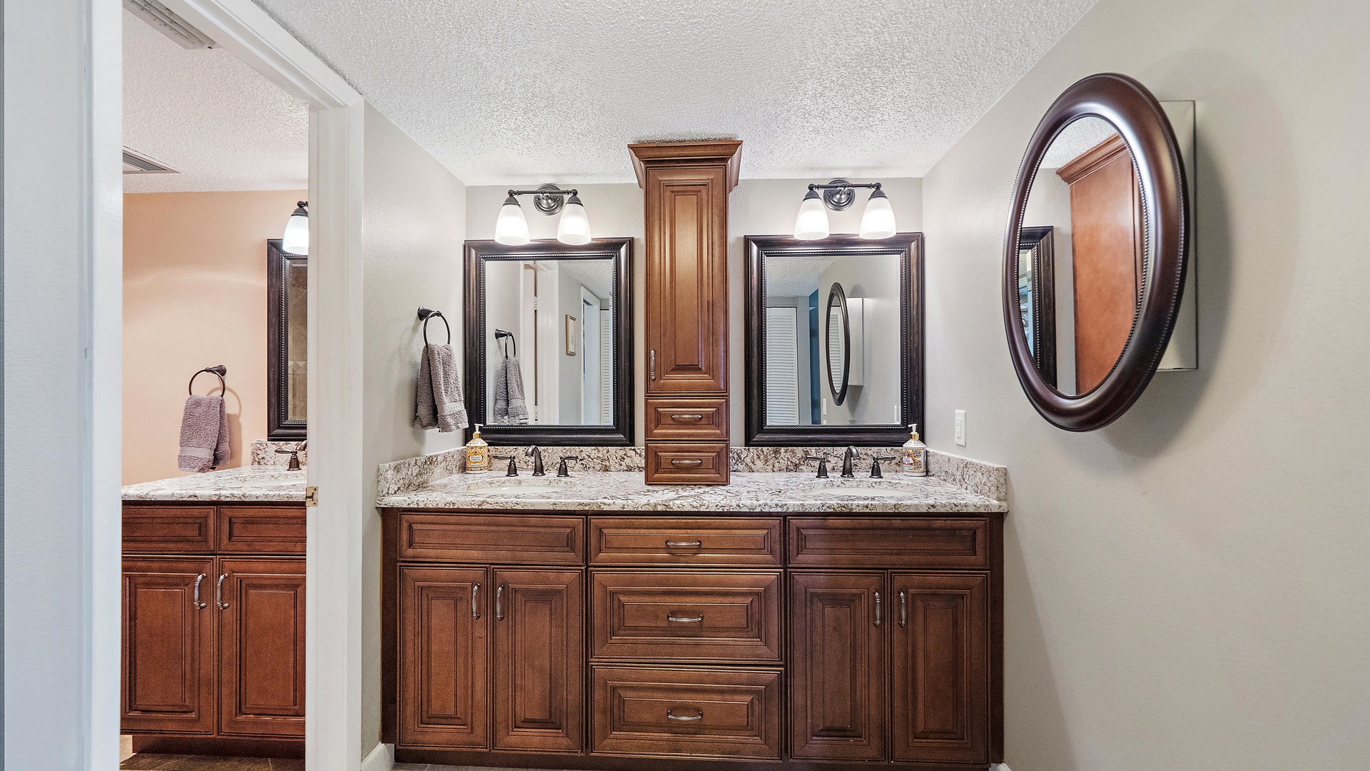 Refresh in your elegant bathroom with dual vanities, granite countertops, and rich wood cabinetry providing ample storage for your getaway essentials.