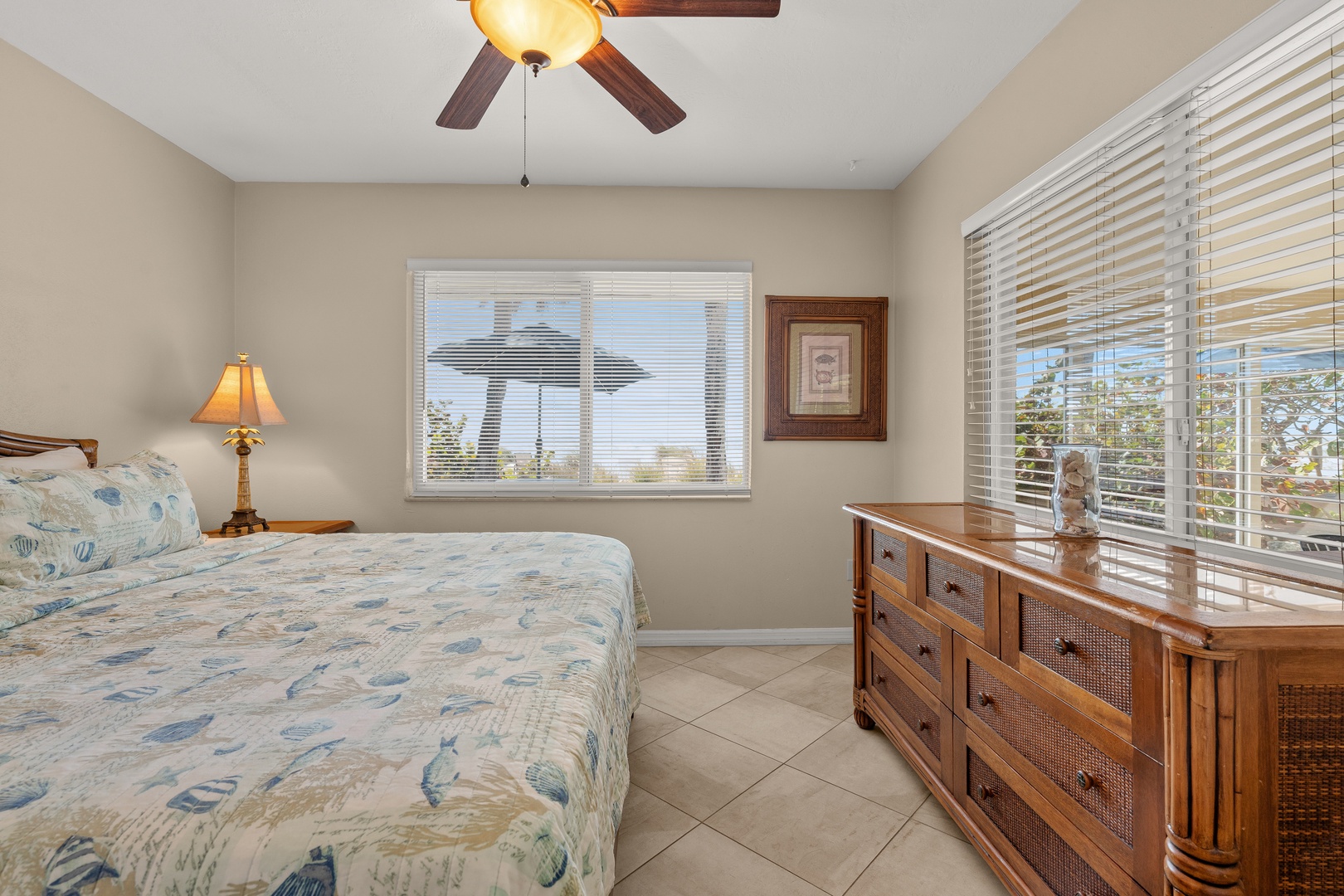 Wake up to gentle breezes from your ceiling fan and natural light streaming through the blinds in this peaceful bedroom retreat.
