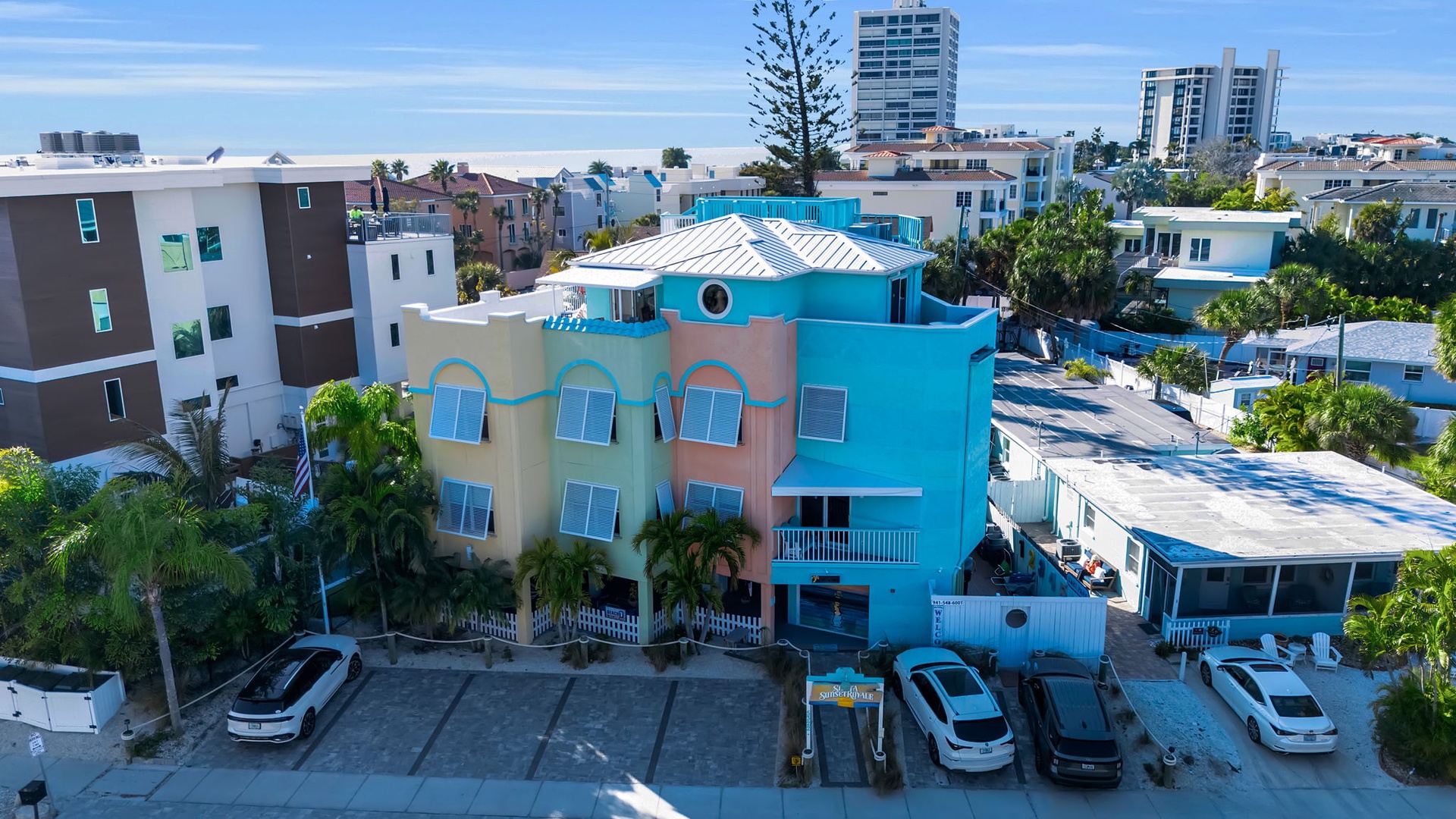 Colorful beachside property nestled in a vibrant coastal neighborhood with convenient parking and easy access to the surrounding area.