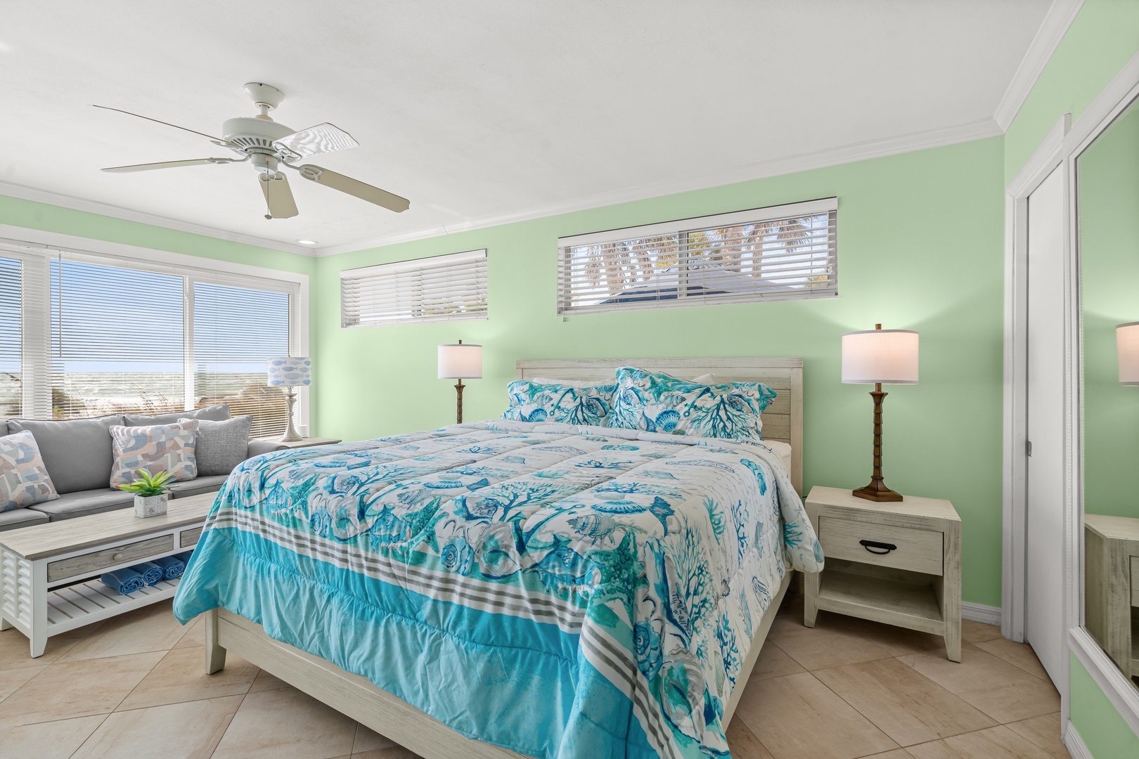 Drift into peaceful sleep in your coastal-inspired bedroom, where soft green walls and tropical blues create the perfect seaside sanctuary.