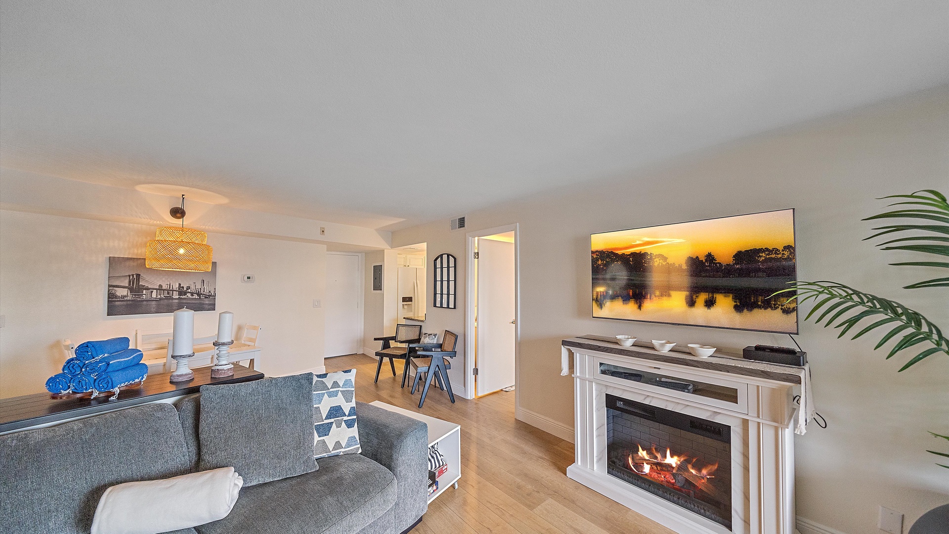 Relax in your spacious living room featuring a cozy fireplace, modern furnishings, and entertainment center - perfect for unwinding after a day of exploring.