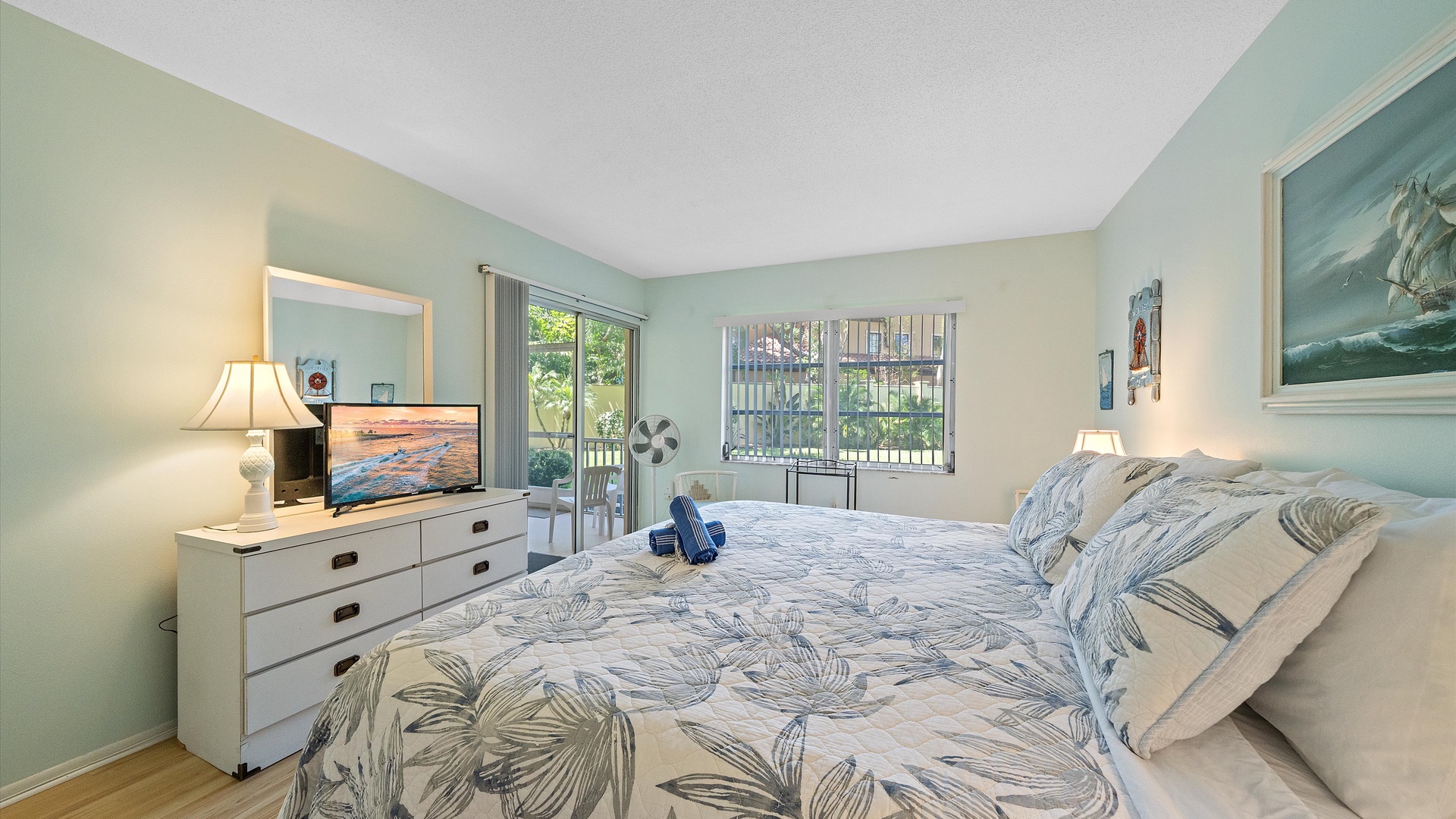 Wake up to coastal calm in your serene bedroom, where soft blues and gentle greens create a peaceful retreat. Enjoy your morning coffee on the private balcony or unwind with garden views.