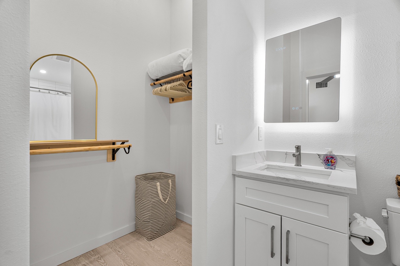 Step into your bright, modern bathroom featuring a spacious vanity, backlit mirror, and sleek storage—perfect for refreshing after a day of adventure.