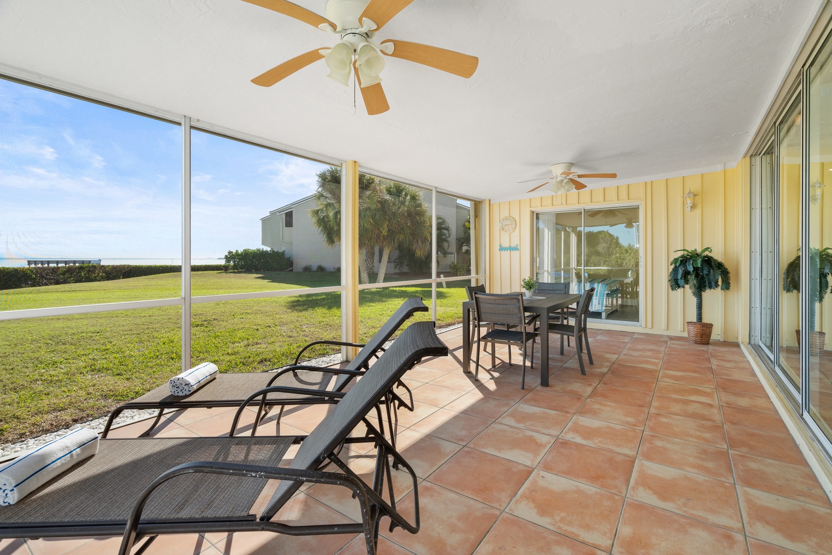 Relax on your screened lanai with ceiling fans keeping you cool while you enjoy peaceful garden views and outdoor dining.