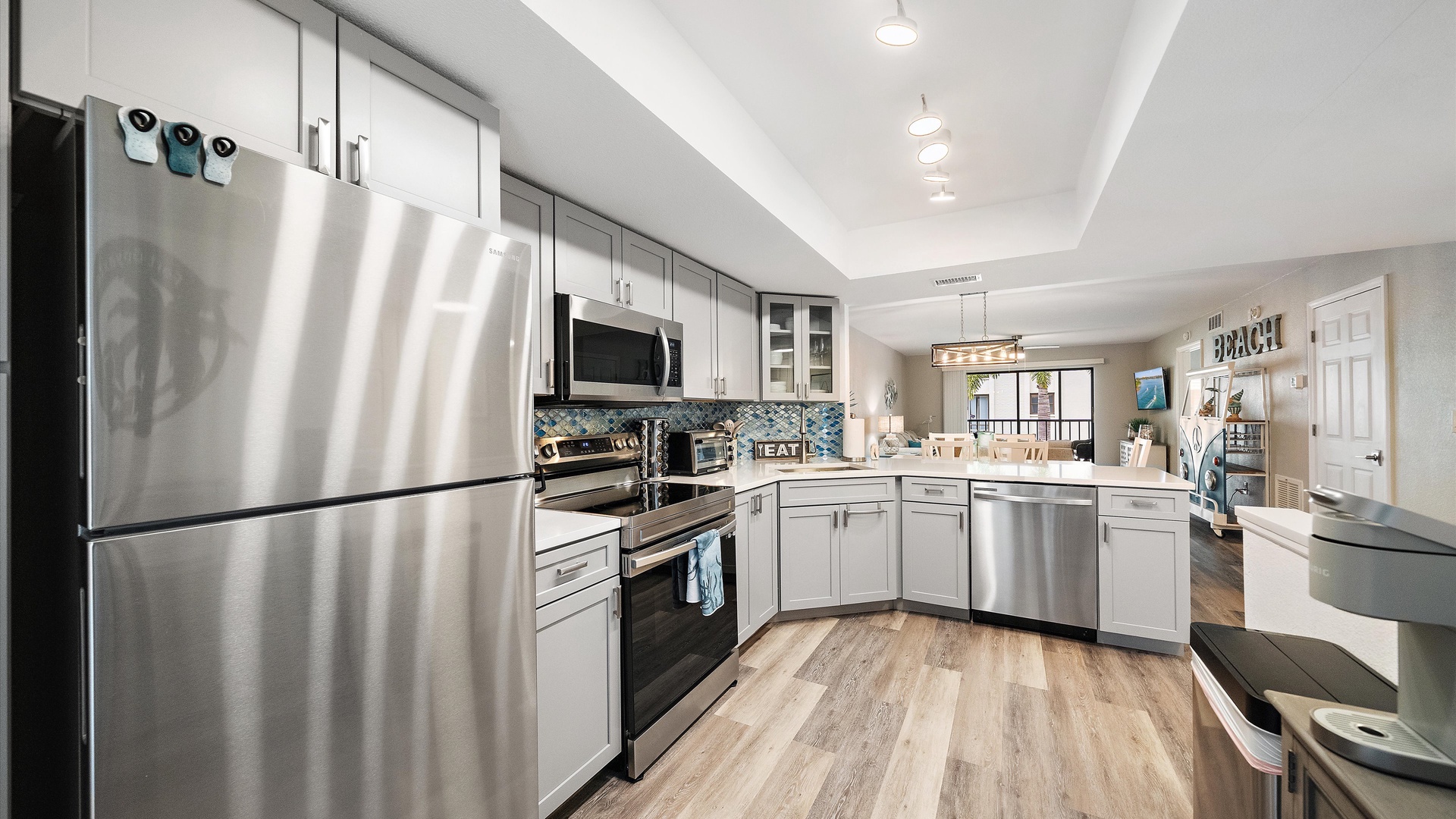 You'll love cooking in this bright, modern kitchen with stainless steel appliances, ample counter space, and soft coastal touches that make meal prep feel effortless.