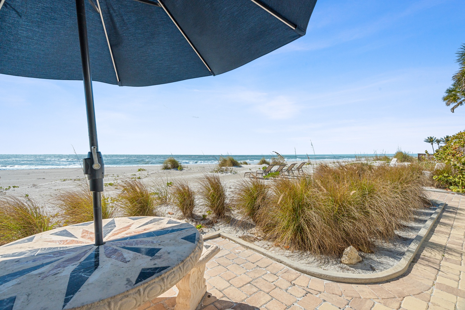 Your private beachfront terrace awaits, with soft sand just steps away and gentle waves beckoning for endless seaside relaxation.
