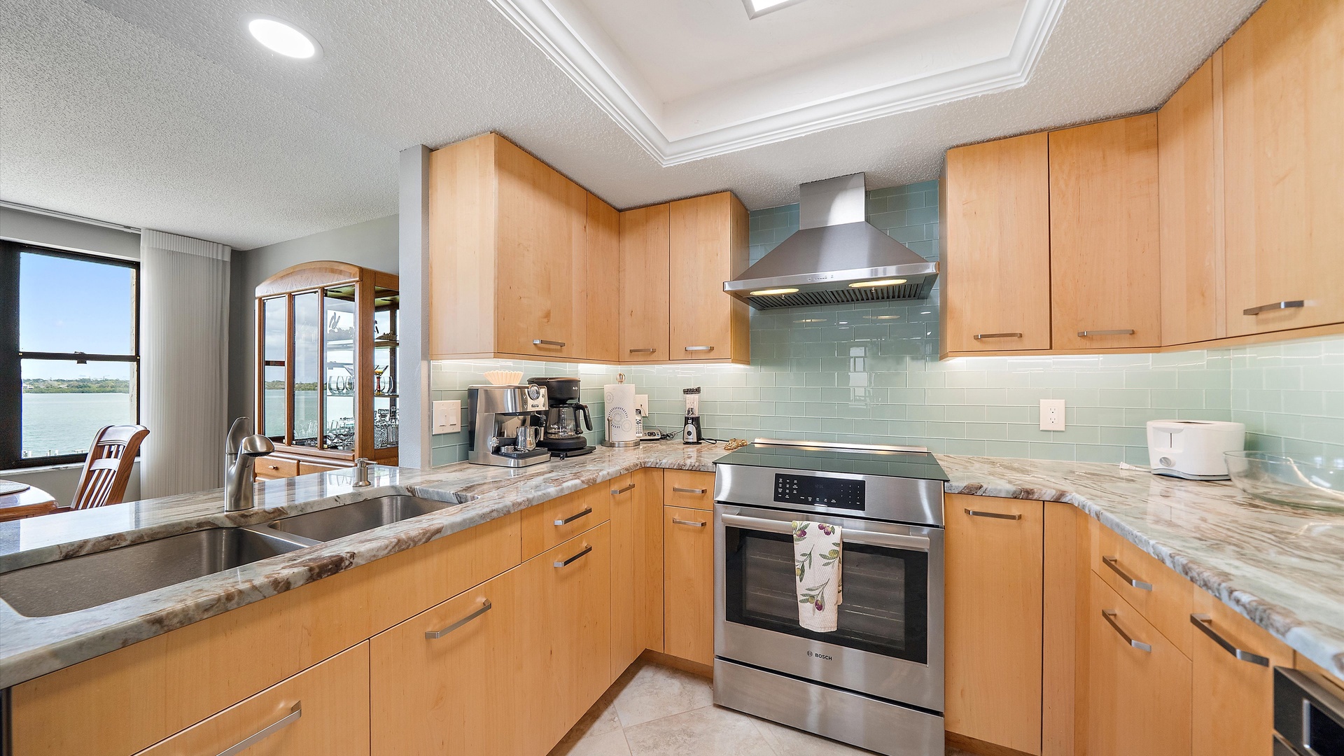 Your gourmet kitchen features granite counters, stainless appliances, and stunning water views to inspire your culinary adventures.
