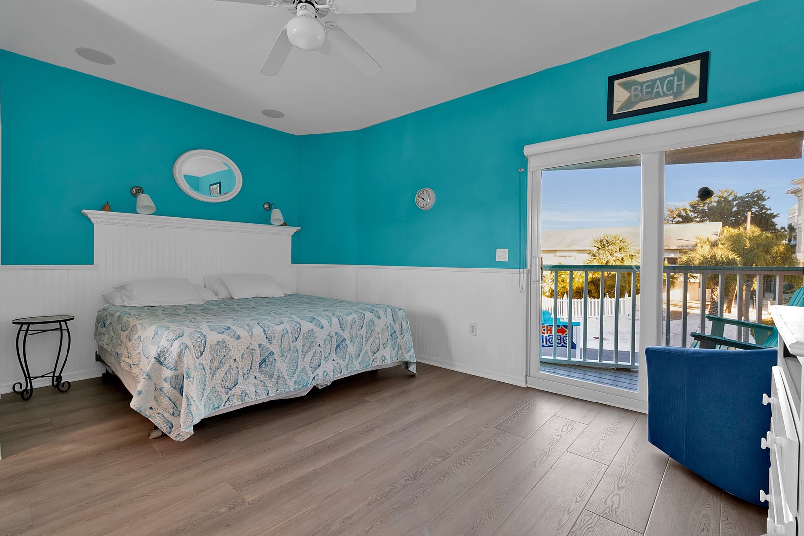 Wake up to vibrant turquoise walls and step through your private balcony doors to enjoy sunny mornings with peaceful views of the property's pool and lush surroundings.