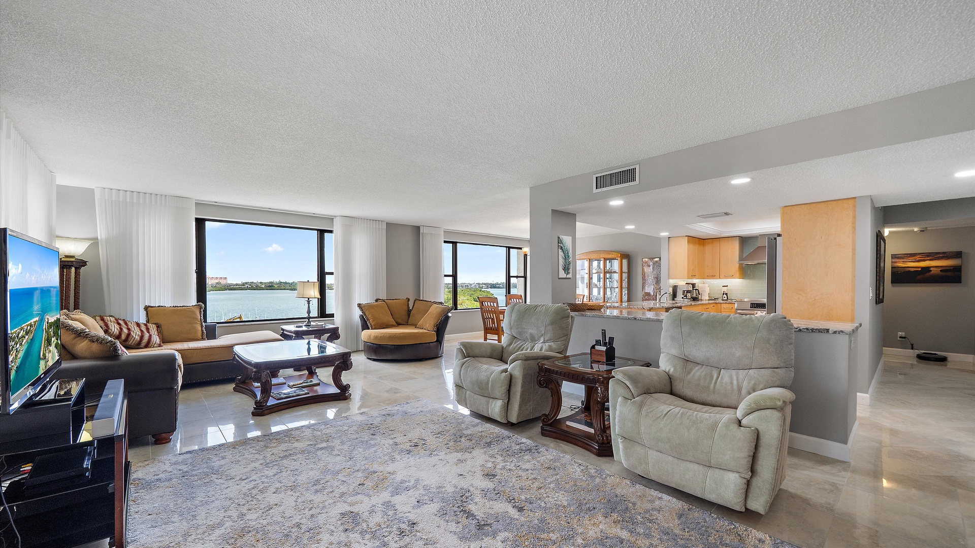 Relax in your spacious living area with stunning water views and modern amenities, perfect for unwinding after exploring.