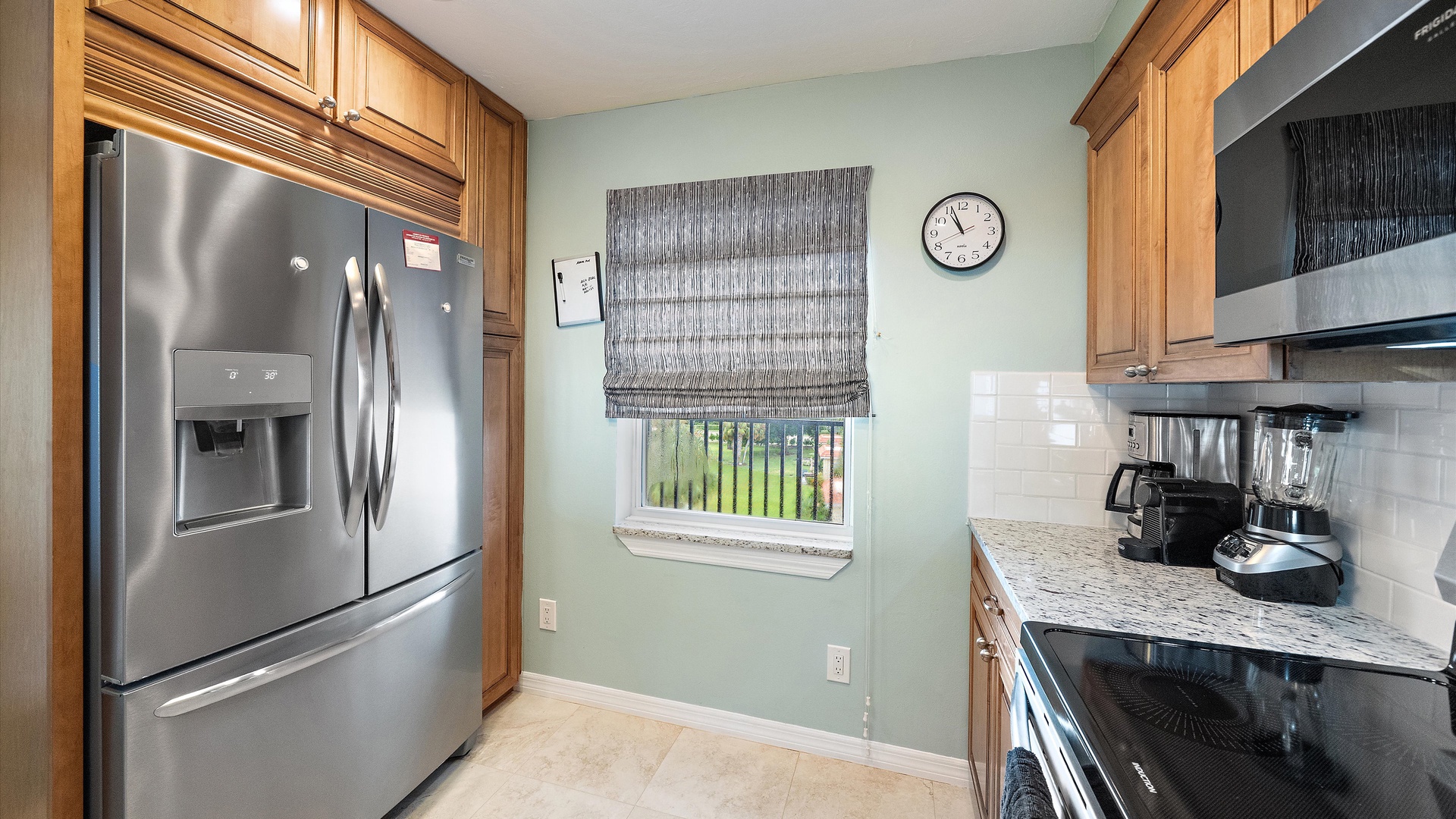 Stainless steel appliances, ample cabinetry, and granite countertops give the kitchen a polished, home-like feel. A full-size refrigerator provides the space that a longer island stay deserves.