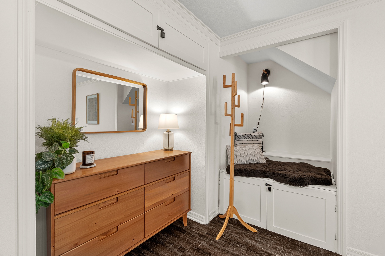 Step inside to find a welcoming entryway with warm wood tones, a stylish mirror, and a cozy nook—your perfect spot to settle in and unwind.