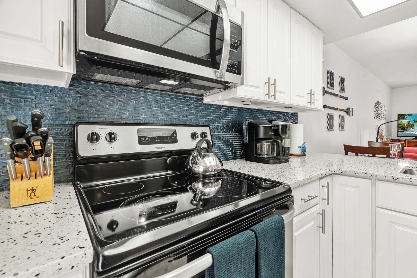 Fully-equipped kitchen featuring modern appliances, ample cookware, Keurig and drip coffee makers.