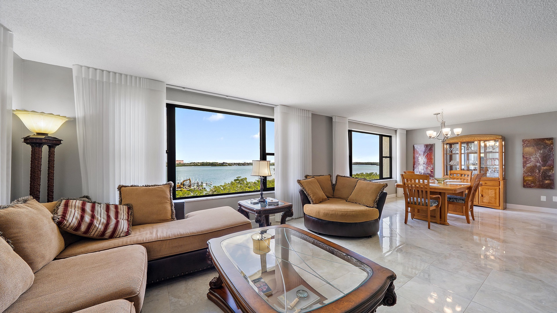 Unwind in your elegant living space with stunning lake views through floor-to-ceiling windows, creating the perfect backdrop for relaxation.