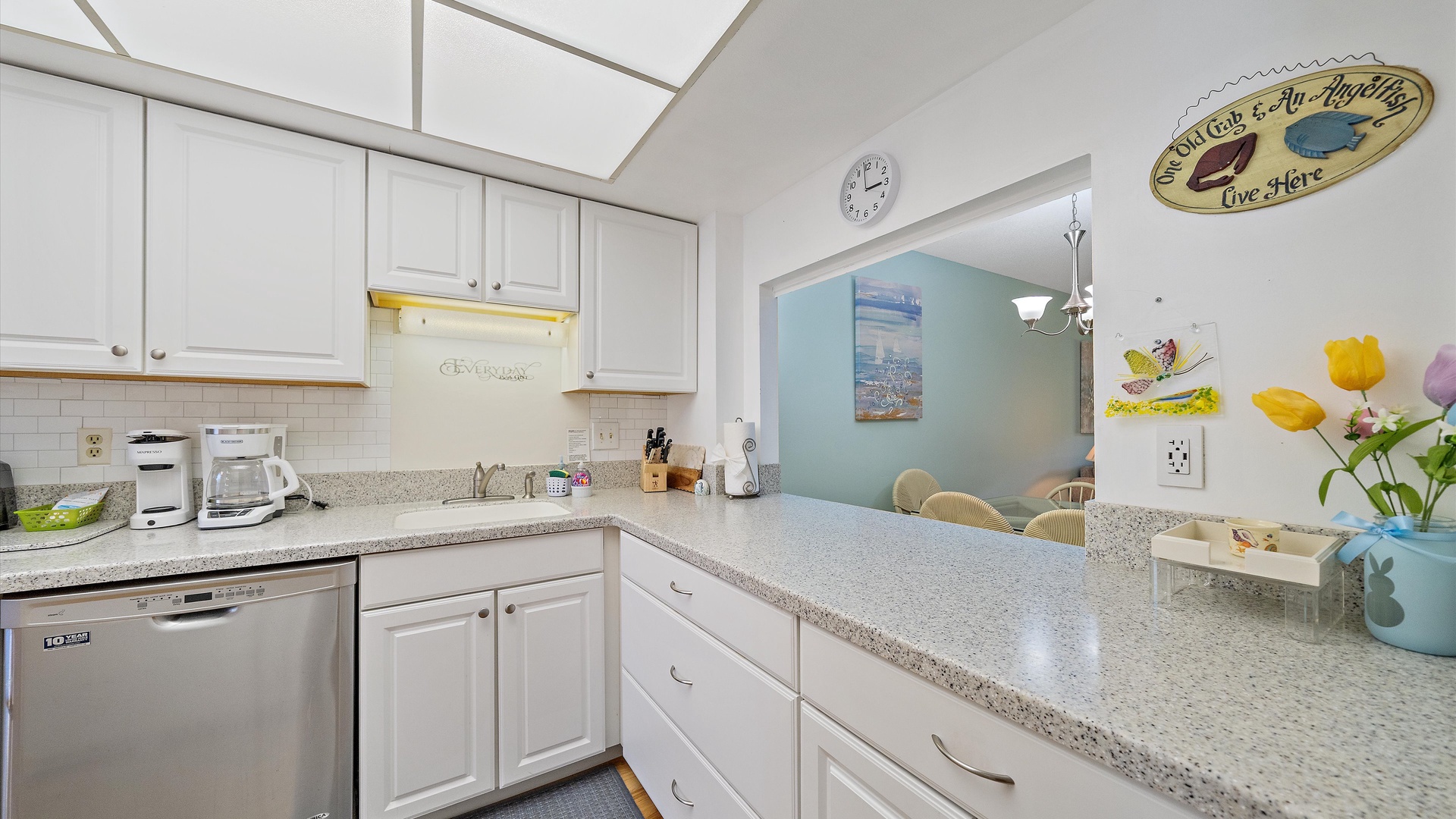 A bright, fully-equipped kitchen awaits you with gleaming countertops, modern appliances, and cheerful coastal touches that make meal prep feel like a breeze.